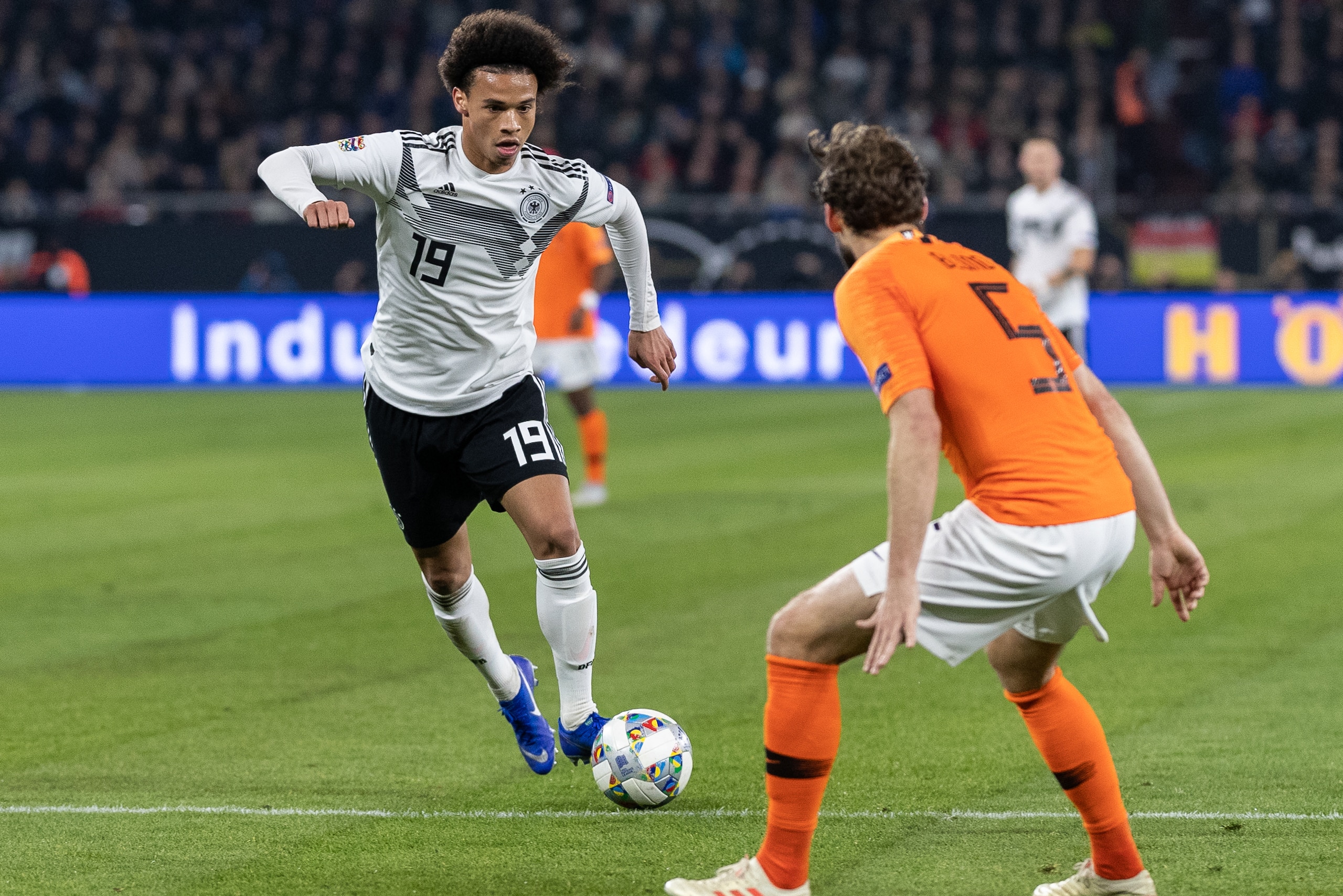 GELSENKIRCHEN, GERMANY - NOVEMBER 19: Leroy Sane of Germany is challenged by Daley Blind of the Netherlands during the UEFA Nations League A group one match between Germany and Netherlands at Veltins-Arena on November 19, 2018 in Gelsenkirchen, Germany. (