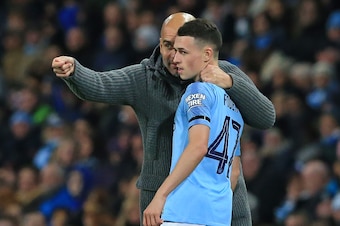 Manchester City's Spanish manager Pep Guardiola (L) speaks with Manchester City's English midfielder Phil Foden (R) during the English League Cup, 4th round football match between Manchester City and Fulham at the Etihad Stadium in Manchester, north west 