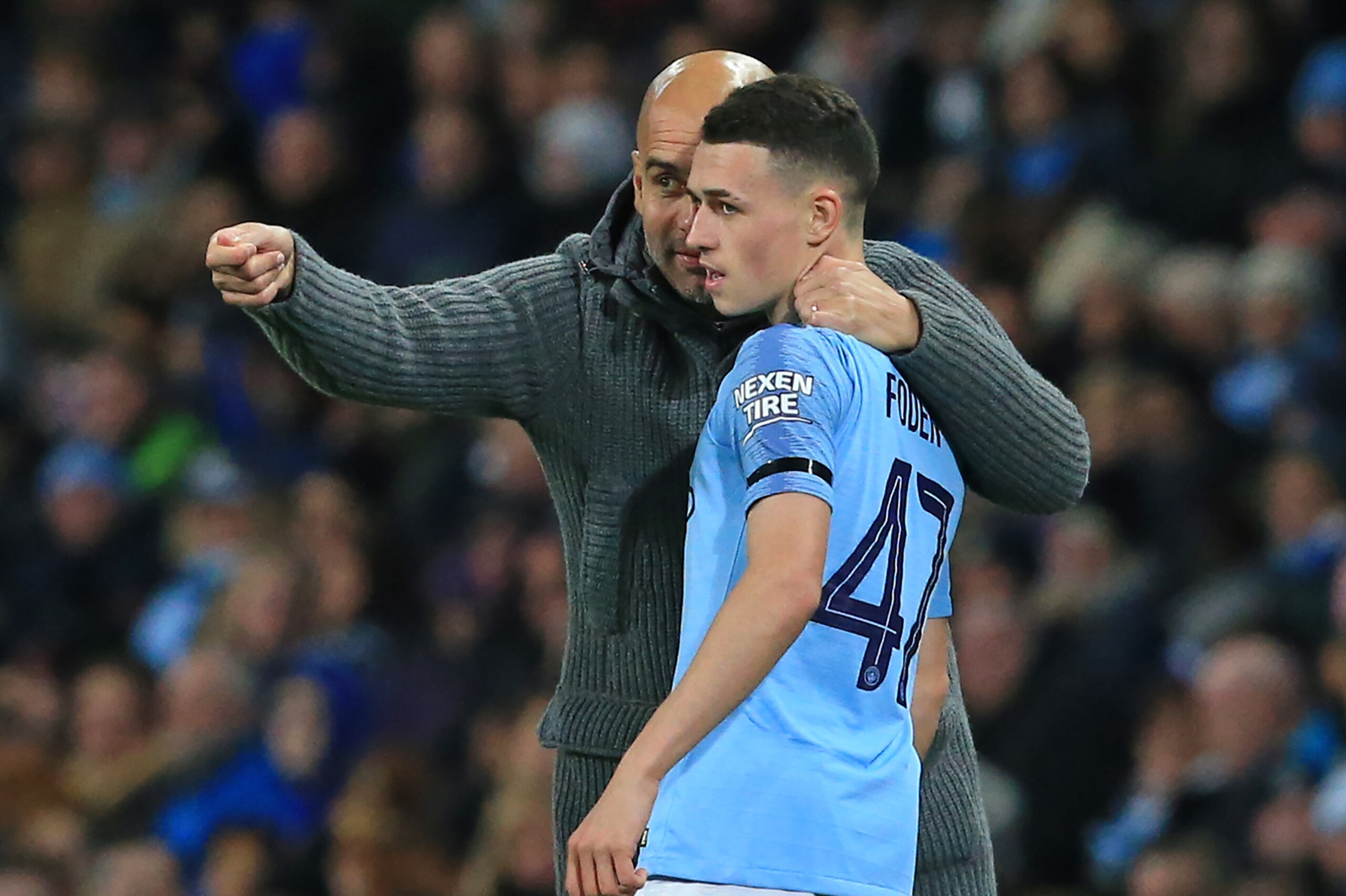 Manchester City's Spanish manager Pep Guardiola (L) speaks with Manchester City's English midfielder Phil Foden (R) during the English League Cup, 4th round football match between Manchester City and Fulham at the Etihad Stadium in Manchester, north west 
