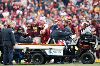 LANDOVER, MD - NOVEMBER 18: Alex Smith #11 of the Washington Redskins is helped off the field after suffering a devastating leg injury during the game against the Houston Texans at FedExField on November 18, 2018 in Landover, Maryland. The Texans won 23-2