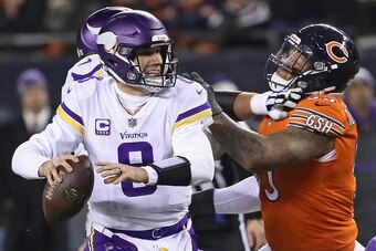 CHICAGO, IL - NOVEMBER 18:  Kirk Cousins #8 of the Minnesota Vikings passes under pressure from Roy Robertson-Harris #95 of the Chicago Bears at Soldier Field on November 18, 2018 in Chicago, Illinois. The Bears defeated the Vikings 25-20.  (Photo by Jona