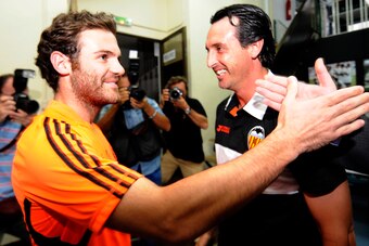 Valencia's coach Unai Emery (R) greets Chelsea's Spanish forward Juan Mata during a press conference at the Mestalla Stadium in Valencial on September 27, 2011 on the eve of the UEFA Champions League football match between Valencia and  Chelsea. AFP PHOTO