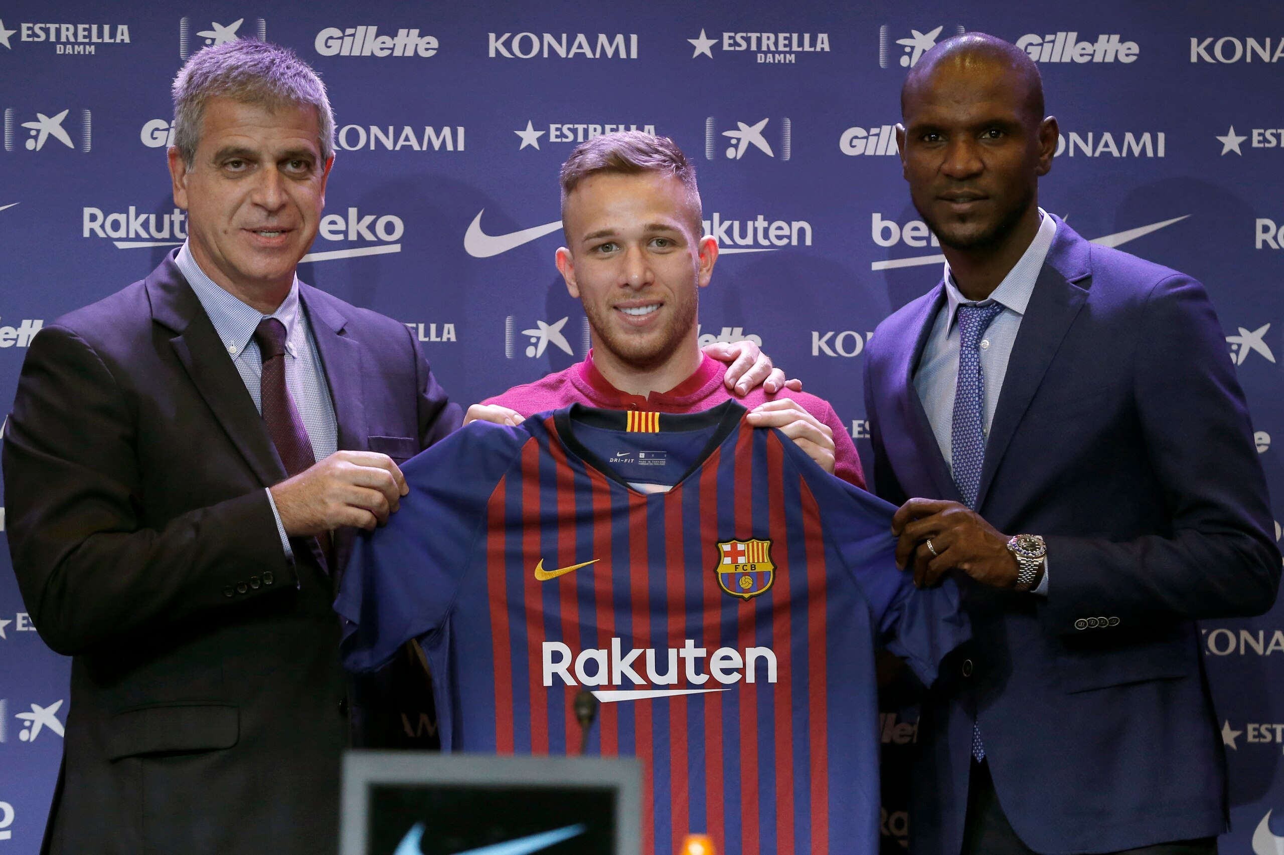 Barcelona's new player Brazilian midfielder Arthur Henrique Ramos de Oliveira Melo (C) poses with Barcelona's vice-president Spanish Jordi Mestre (L) and Barcelona's technical secretary French Eric Abidal (R) during a press conference at the Auditorium 18