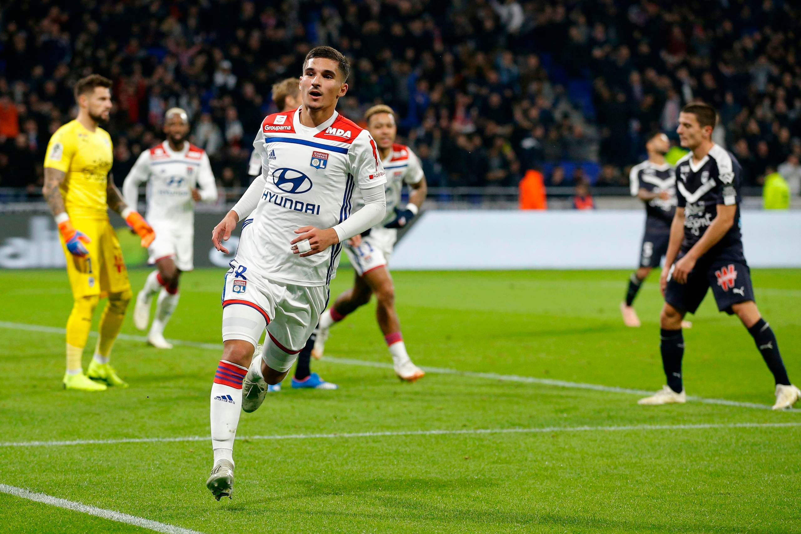 Lyon's French midfielder Houssem Aouar (L) reacts after scoring during the French L1 football match between Olympique Lyonnais and Girondins de Bordeaux on November 3, 2018, at the Groupama Stadium in Decines-Charpieu, central eastern France. (Photo by Al Lyon's French midfielder Houssem Aouar (L) reacts after scoring during the French L1 football match between Olympique Lyonnais and Girondins de Bordeaux on November 3, 2018, at the Groupama Stadium in Decines-Charpieu, central eastern France. (Photo by Al