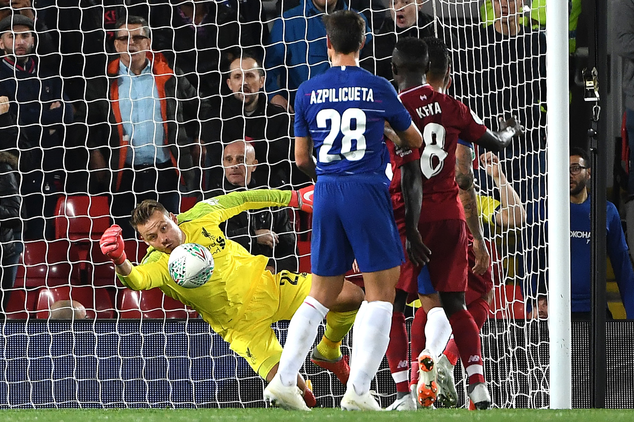 Liverpool's Belgian goalkeeper Simon Mignolet (L) fails to save a shot from Chelsea's Brazilian defender Emerson Palmieri during the English League Cup third round football match between Liverpool and Chelsea at Anfield in Liverpool, north west England on