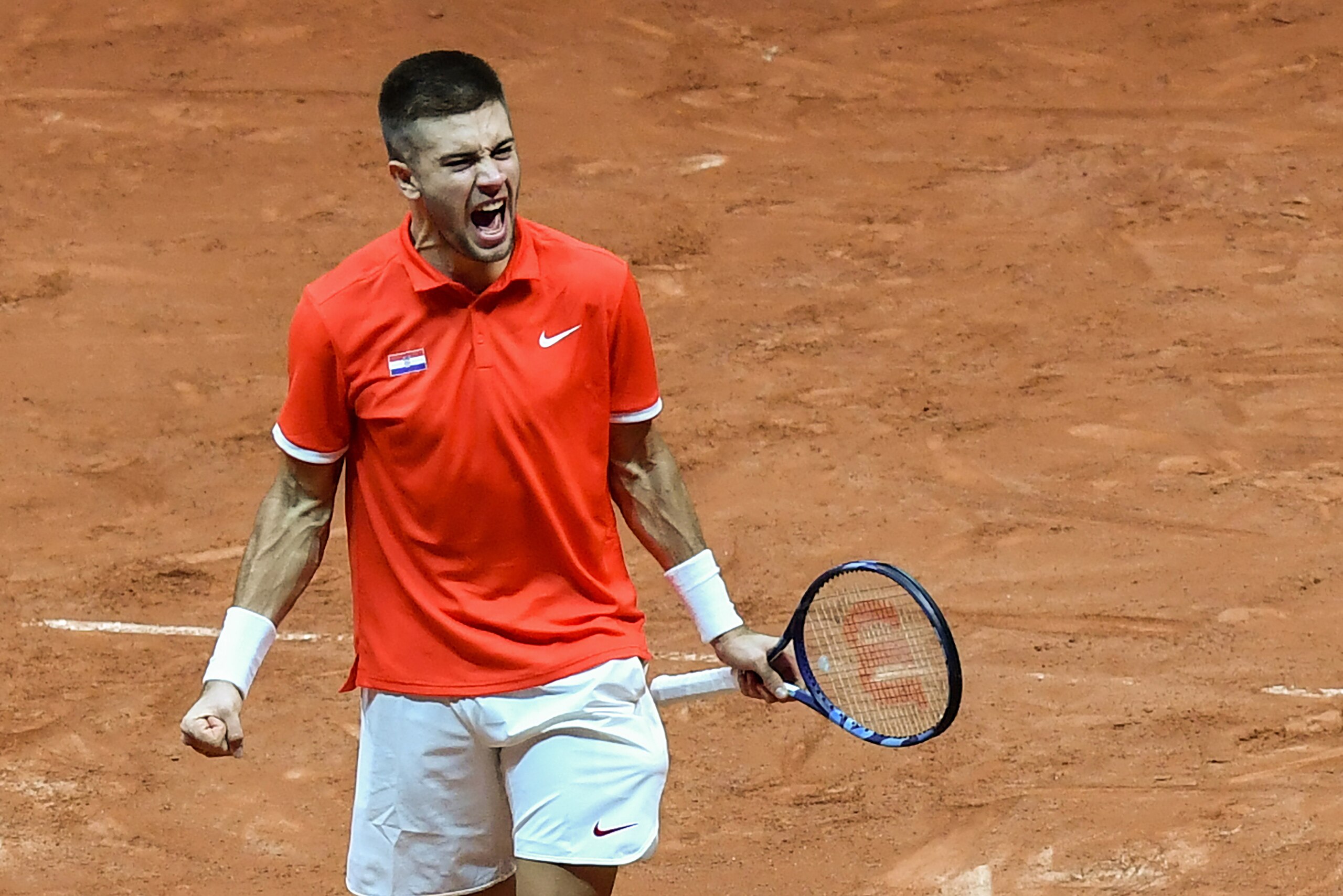 Croatia's Borna Coric celebrates after victory in his singles rubber against France's Jeremy Chardy  during the Davis Cup final tennis match between France and Croatia at The Pierry-Mauroy Stadium in northern France on November 23, 2018. (Photo by DENIS C