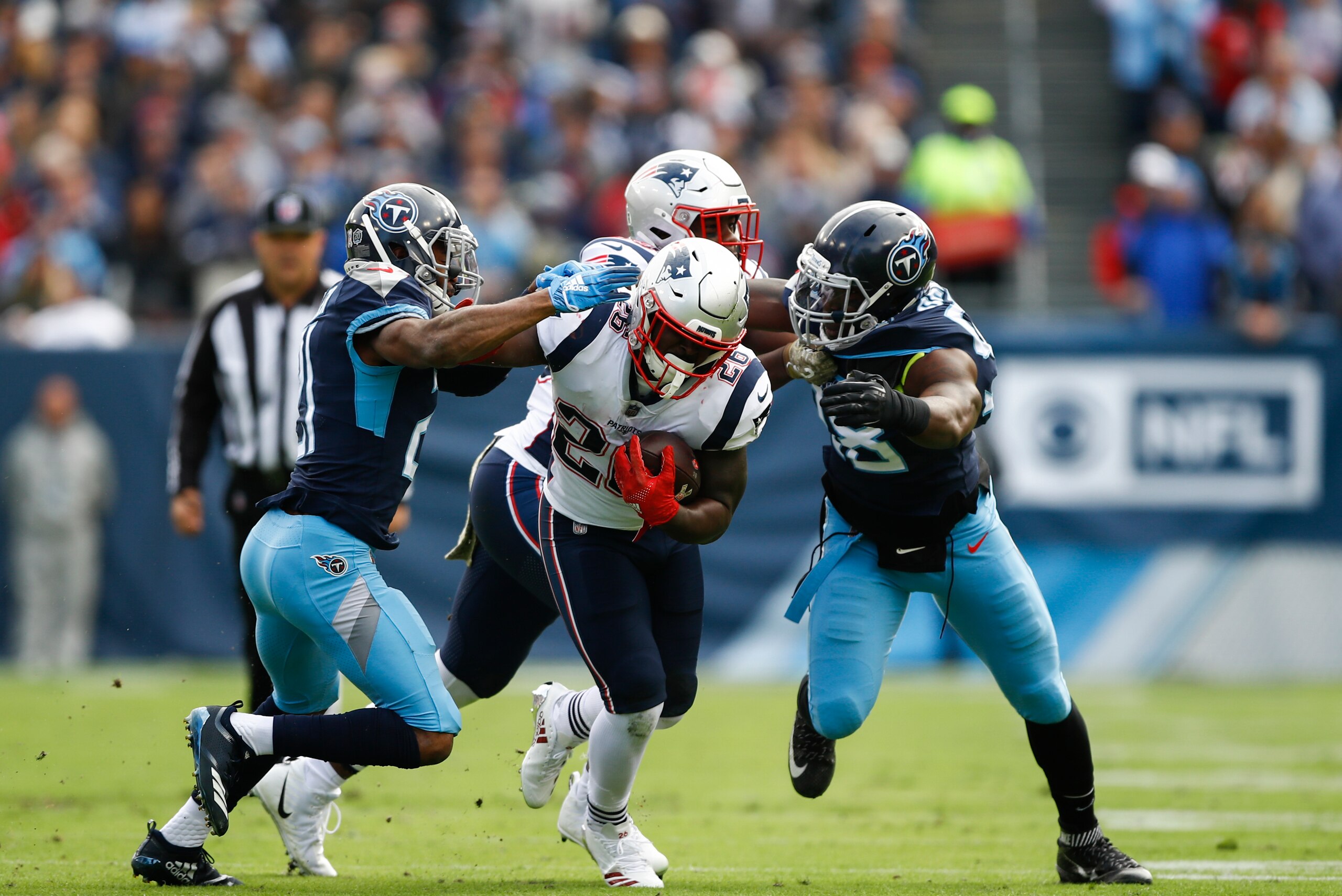 NASHVILLE, TN - NOVEMBER 11: Sony Michel #26 of the New England Patriots runs with the ball against the Tennessee Titans while defended at Nissan Stadium on November 11, 2018 in Nashville, Tennessee. (Photo by Wesley Hitt/Getty Images)