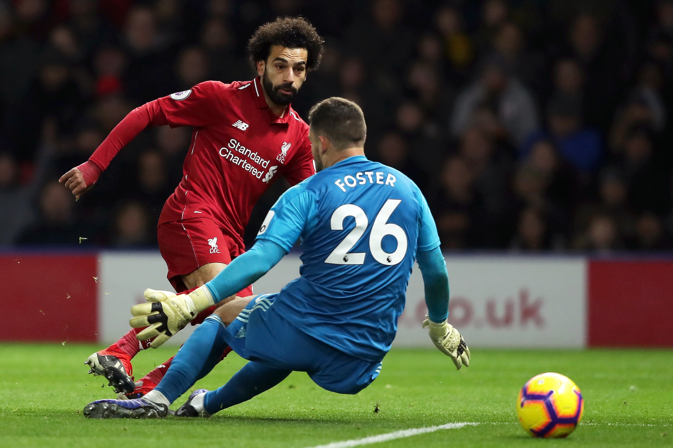 WATFORD, ENGLAND - NOVEMBER 24: Mohamed Salah of Liverpool is challenged by Ben Foster of Watford during the Premier League match between Watford FC and Liverpool FC at Vicarage Road on November 24, 2018 in Watford, United Kingdom. (Photo by Richard Hea WATFORD, ENGLAND - NOVEMBER 24: Mohamed Salah of Liverpool is challenged by Ben Foster of Watford during the Premier League match between Watford FC and Liverpool FC at Vicarage Road on November 24, 2018 in Watford, United Kingdom. (Photo by Richard Hea