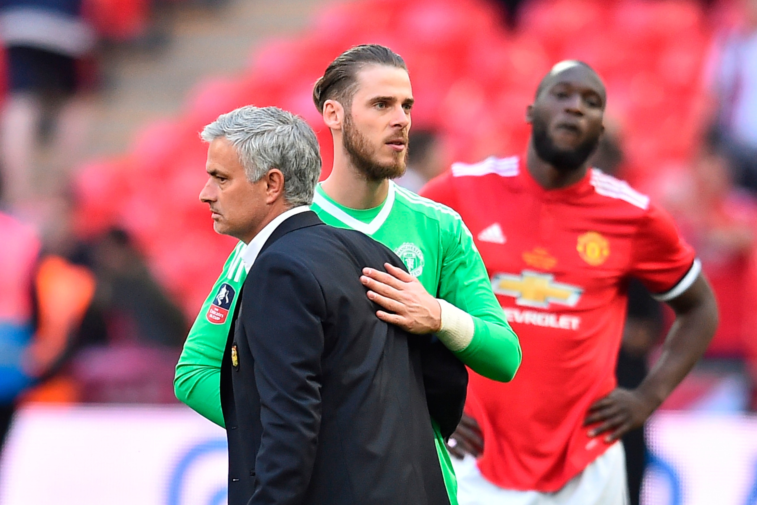Manchester United's Portuguese manager Jose Mourinho (L) reacts with Manchester United's Spanish goalkeeper David de Gea (C) after losing the English FA Cup final football match between Chelsea and Manchester United at Wembley stadium in London on May 19,