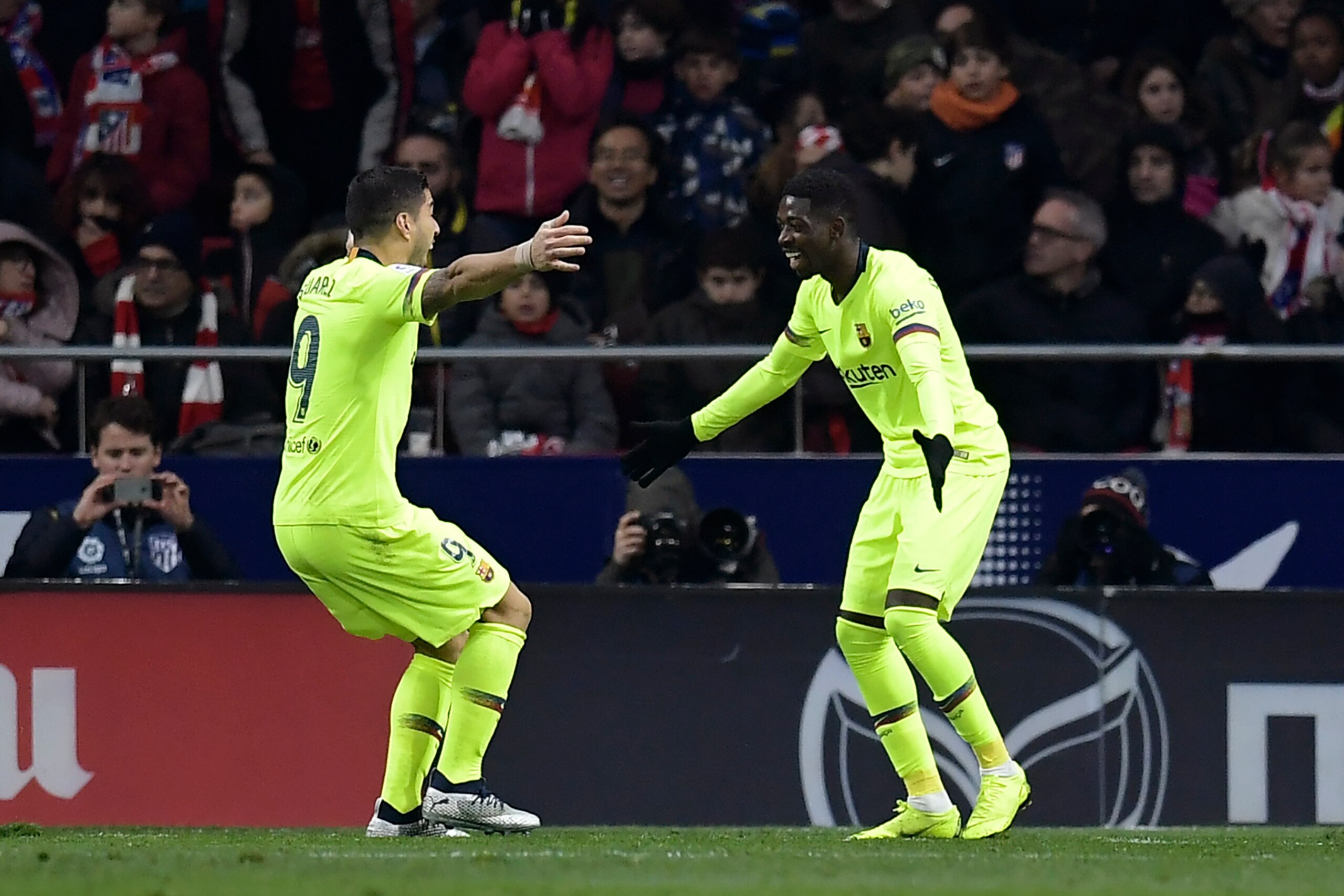 Barcelona's French forward Ousmane Dembele (R) celebrates with Barcelona's Uruguayan forward Luis Suarez after scoring a goal during the Spanish league football match between Club Atletico de Madrid and FC Barcelona at the Wanda Metropolitano stadium in M