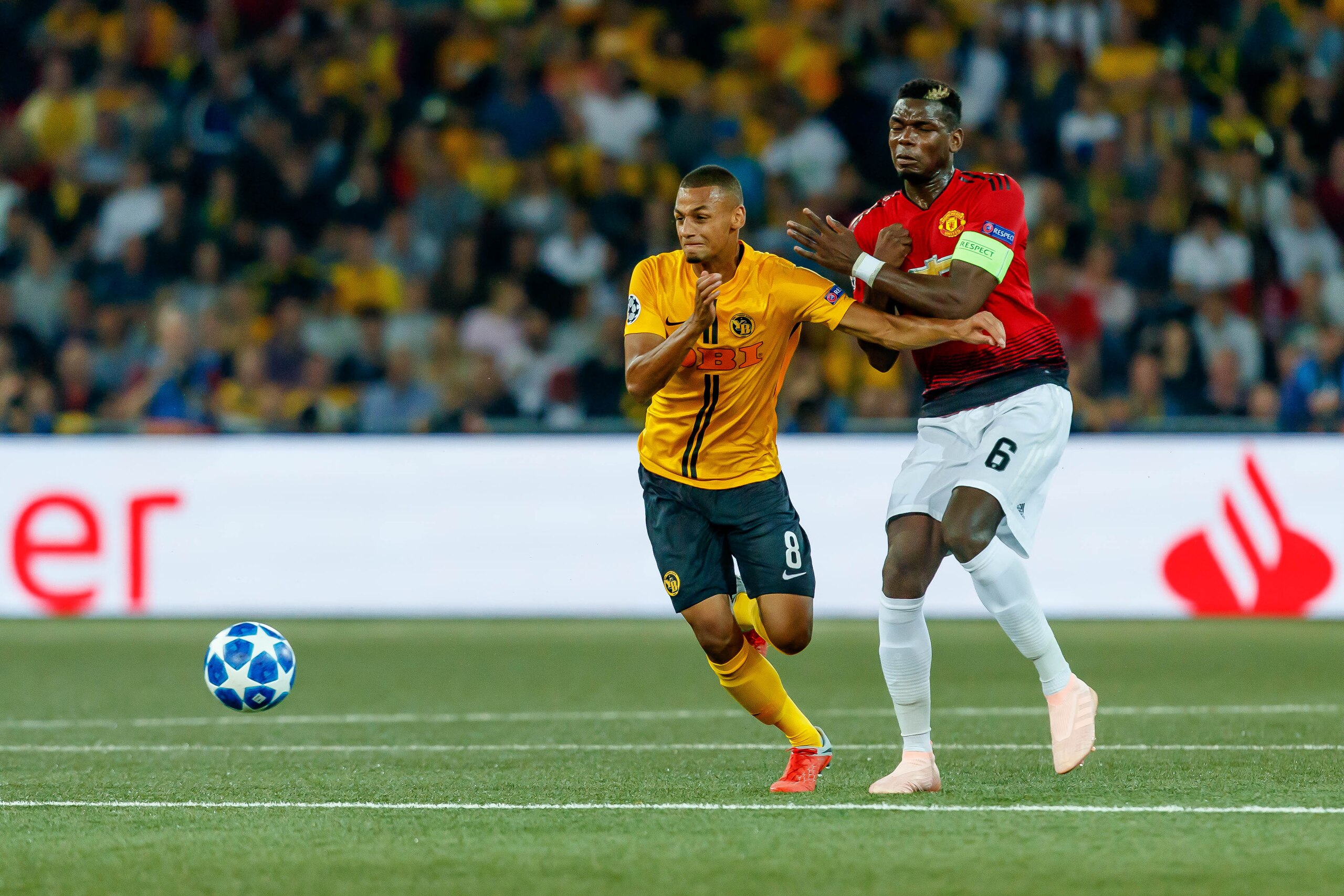 BERN, SWITZERLAND - SEPTEMBER 19: Djibril Sow of BSC Young Boys and Paul Pogba of Manchester United battle for the ball during the UEFA Champions League Group H match between BSC Young Boys and Manchester United at Stade de Suisse, Wankdorf on September 1