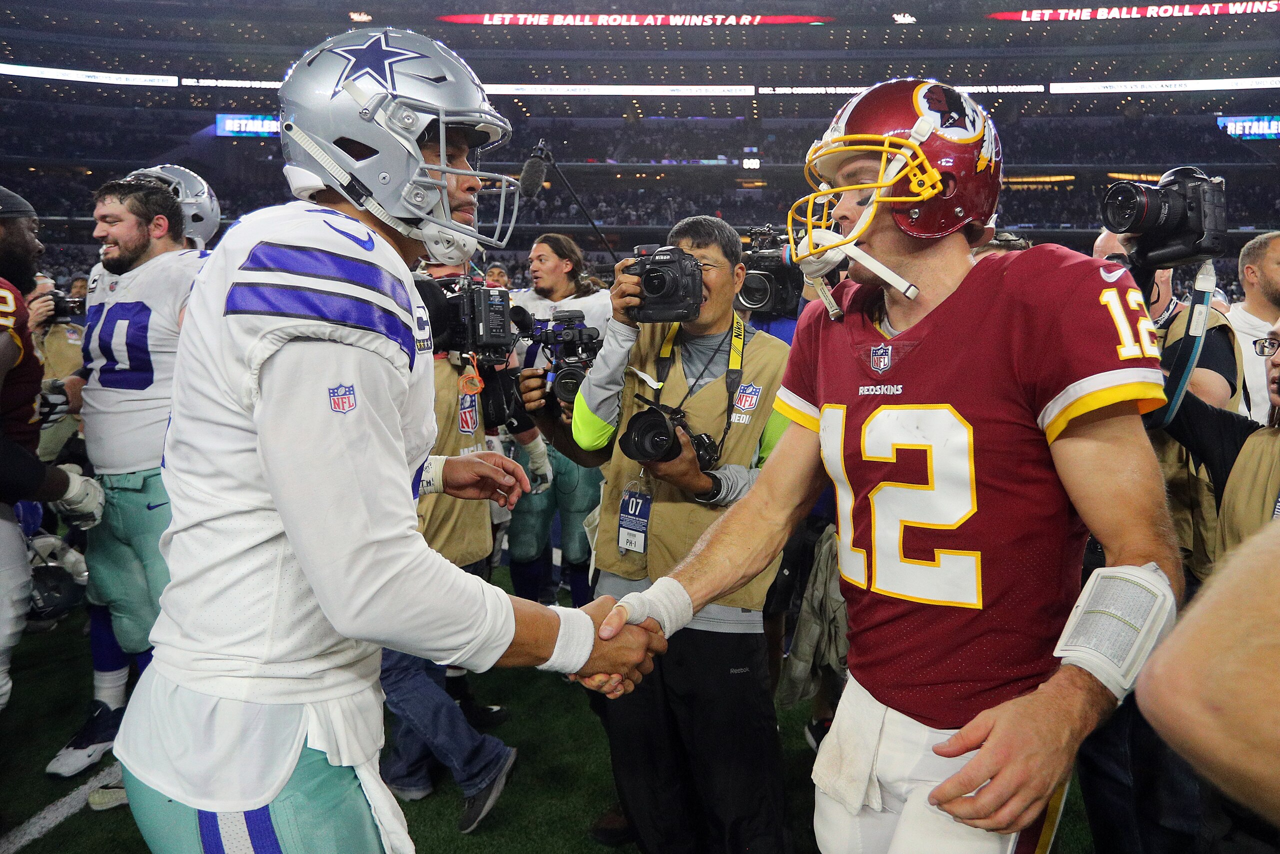 ARLINGTON, TEXAS - NOVEMBER 22: Dak Prescott #4 of the Dallas Cowboys shakes hands with Colt McCoy #12 of the Washington Redskins after the game at AT&T Stadium on November 22, 2018 in Arlington, Texas. (Photo by Richard Rodriguez/Getty Images)