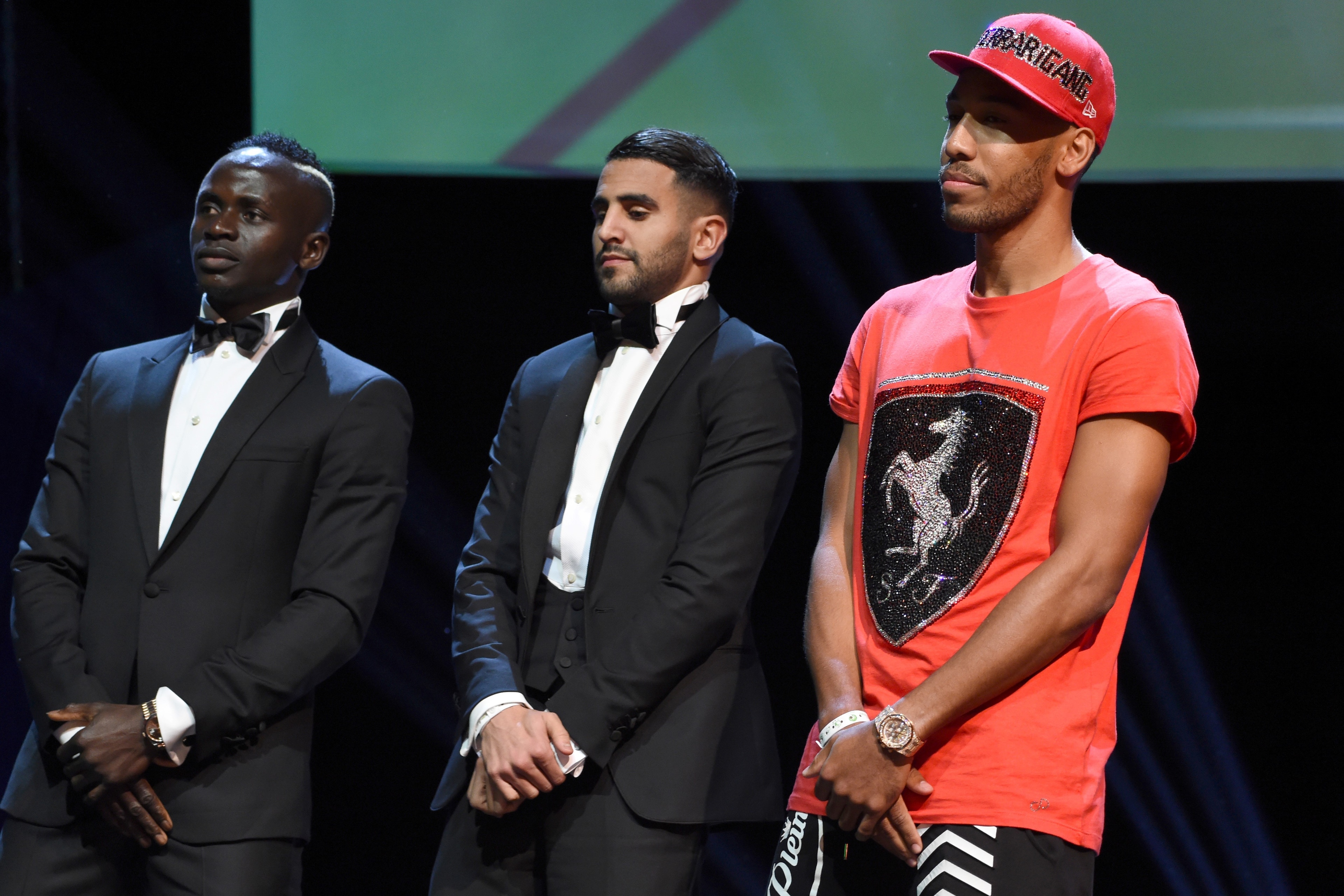 African best players from left, Senegalese Sadio Mane, Algerian Riyad Mahrez, and Gabonese Pierre-Emerick Aubameyang stands for the announcement of African Footballer of the Year in Abuja, on January 5, 2017. 
Algerian and Leicester striker Riyad Mahrez h