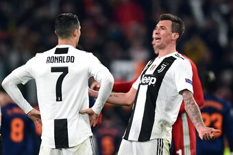 Juventus' Croatian forward Mario Mandzukic (R) and Juventus' Portuguese forward Cristiano Ronaldo (L) react at the end of the UEFA Champions League group H football match Juventus vs Valence on November 27, 2018 at the Juventus stadium in Turin. (Photo by