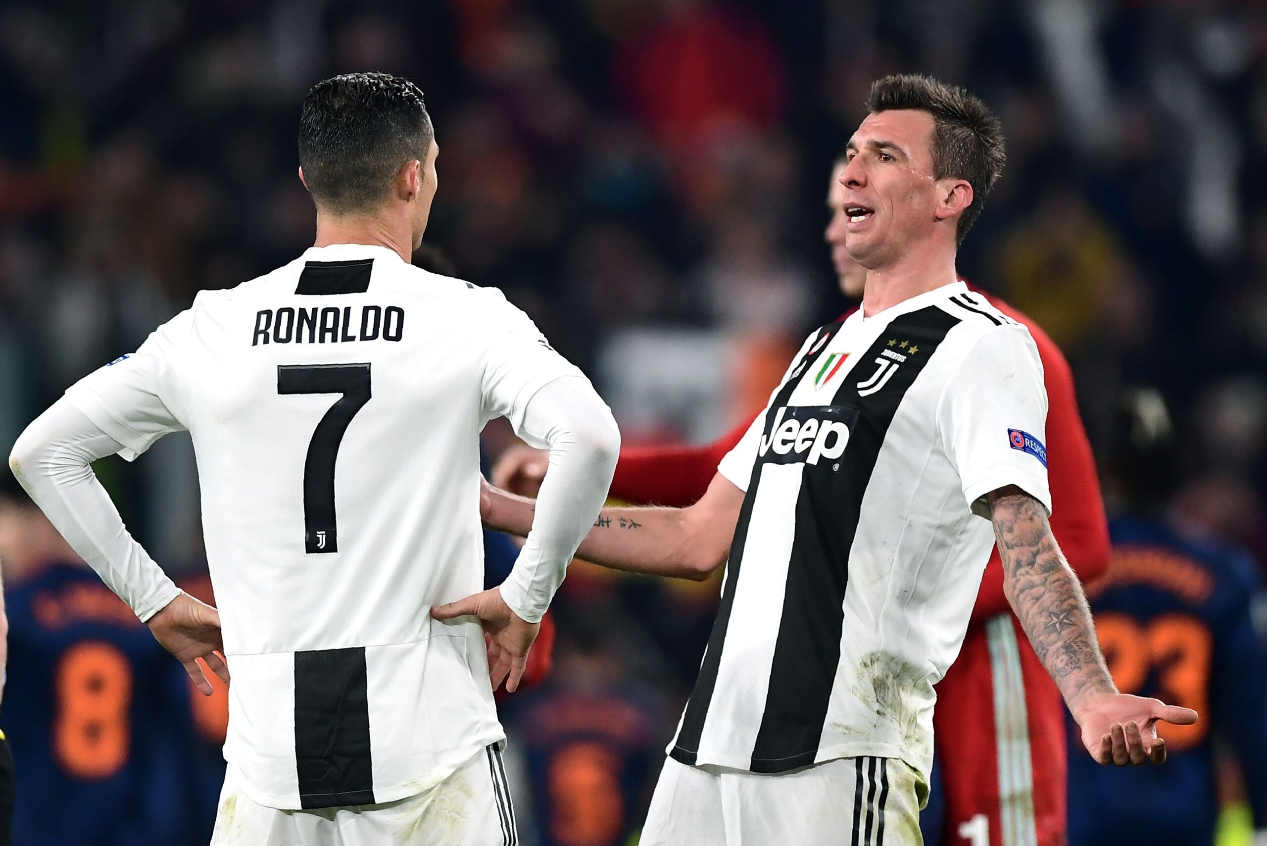 Juventus' Croatian forward Mario Mandzukic (R) and Juventus' Portuguese forward Cristiano Ronaldo (L) react at the end of the UEFA Champions League group H football match Juventus vs Valence on November 27, 2018 at the Juventus stadium in Turin. (Photo by
