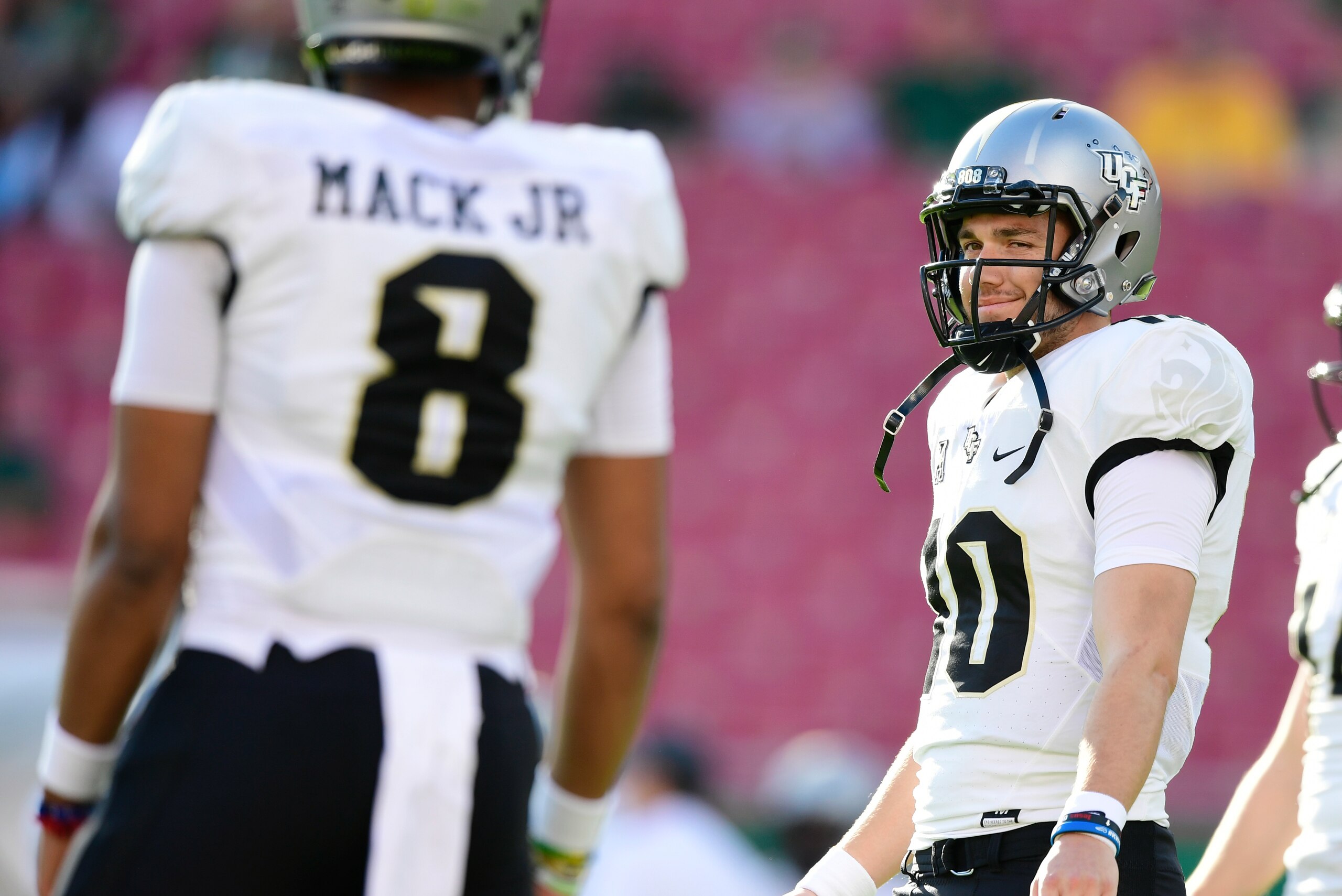 TAMPA, FLORIDA - NOVEMBER 23: McKenzie Milton #10 practices with Darriel Mack Jr. #8 of the UCF Knights before a game against the South Florida Bulls at Raymond James Stadium on November 23, 2018 in Tampa, Florida. (Photo by Julio Aguilar/Getty Images) TAMPA, FLORIDA - NOVEMBER 23: McKenzie Milton #10 practices with Darriel Mack Jr. #8 of the UCF Knights before a game against the South Florida Bulls at Raymond James Stadium on November 23, 2018 in Tampa, Florida. (Photo by Julio Aguilar/Getty Images)