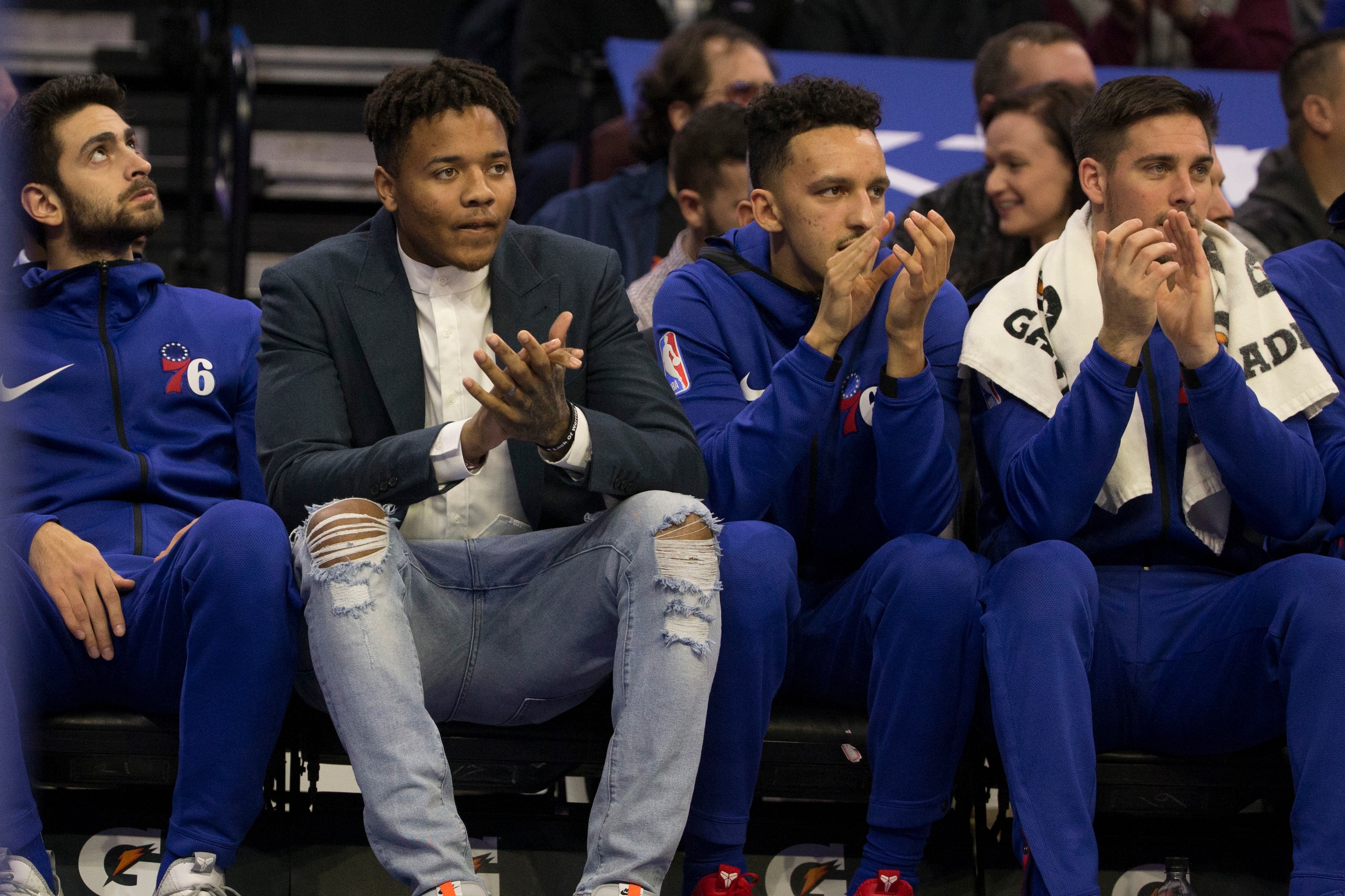 PHILADELPHIA, PA - NOVEMBER 21: (L-R) Furkan Korkmaz #30, Markelle Fultz #20, Landry Shamet #1, and T.J. McConnell #12 of the Philadelphia 76ers watch the game from the bench in the first quarter against the New Orleans Pelicans at the Wells Fargo Center 