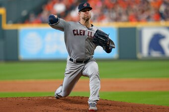 HOUSTON, TX - OCTOBER 05:  Corey Kluber #28 of the Cleveland Indians delivers a pitch in the second inning against the Houston Astros during Game One of the American League Division Series at Minute Maid Park on October 5, 2018 in Houston, Texas.  (Photo 