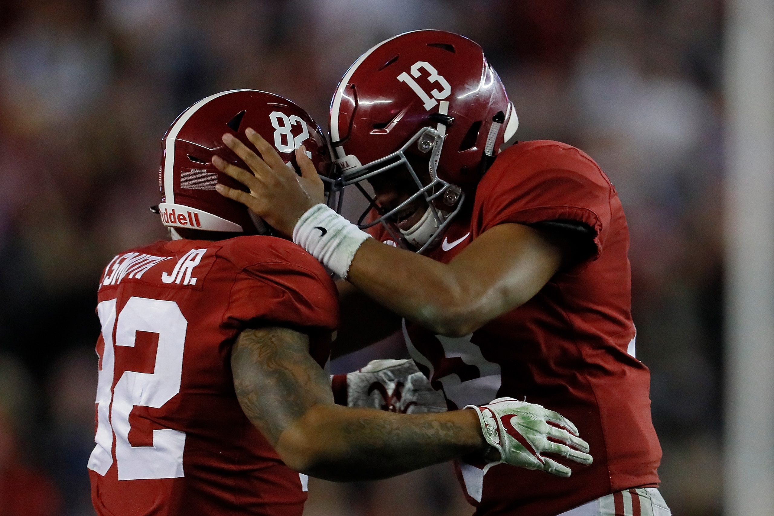 TUSCALOOSA, AL - NOVEMBER 24:  Tua Tagovailoa #13 of the Alabama Crimson Tide reacts after passing for a touchdown to Henry Ruggs III #11 against the Auburn Tigers with Irv Smith Jr. #82 at Bryant-Denny Stadium on November 24, 2018 in Tuscaloosa, Alabama.