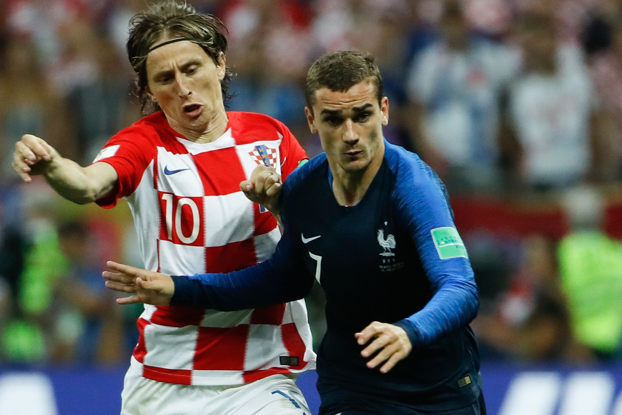 Croatia's midfielder Luka Modric and France's forward Antoine Griezmann vie for the ball during the Russia 2018 World Cup final football match between France and Croatia at the Luzhniki Stadium in Moscow on July 15, 2018. (Photo by Odd ANDERSEN / AFP) / R