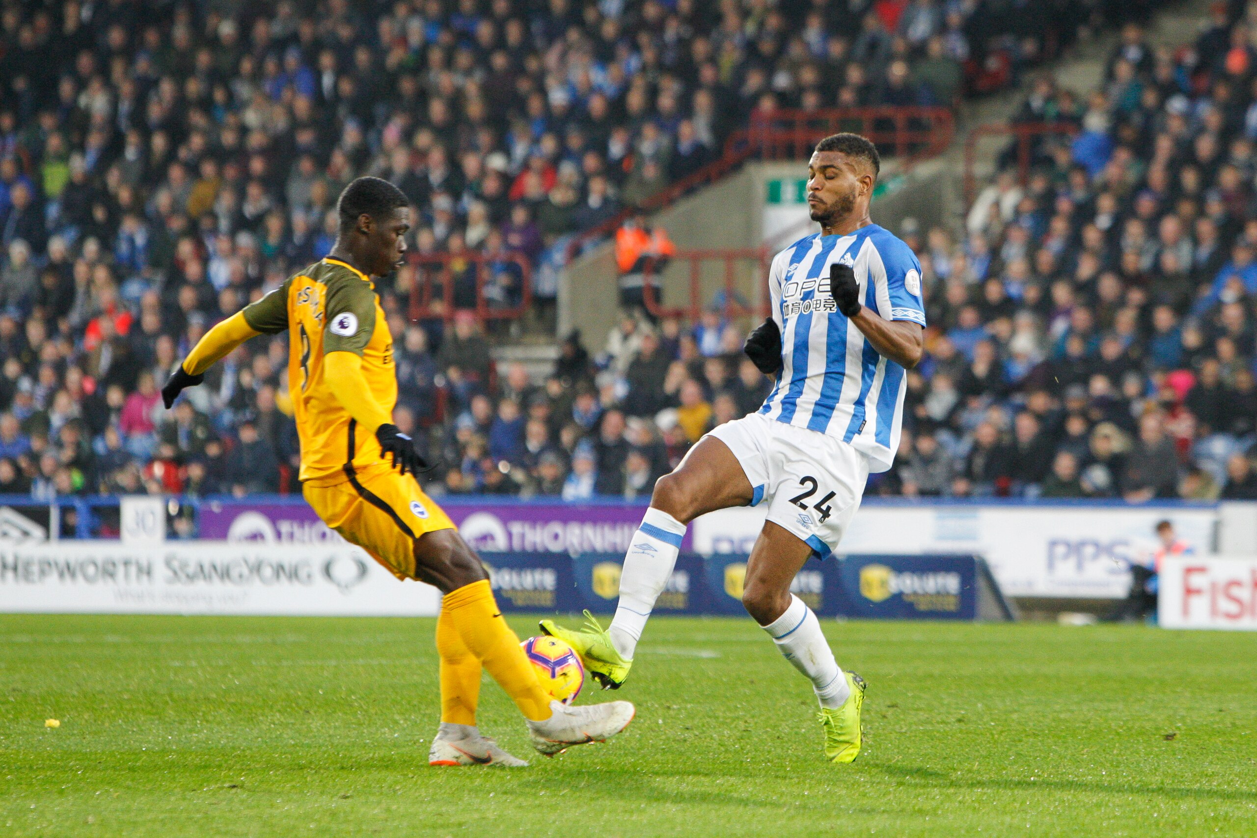 HUDDERSFIELD, ENGLAND - DECEMBER 01: Steve Mounié of Huddersfield Town challenges for the ball which leads to his sending off during the Premier League match between Huddersfield Town and Brighton & Hove Albion at John Smith's Stadium on December 1, 2018 