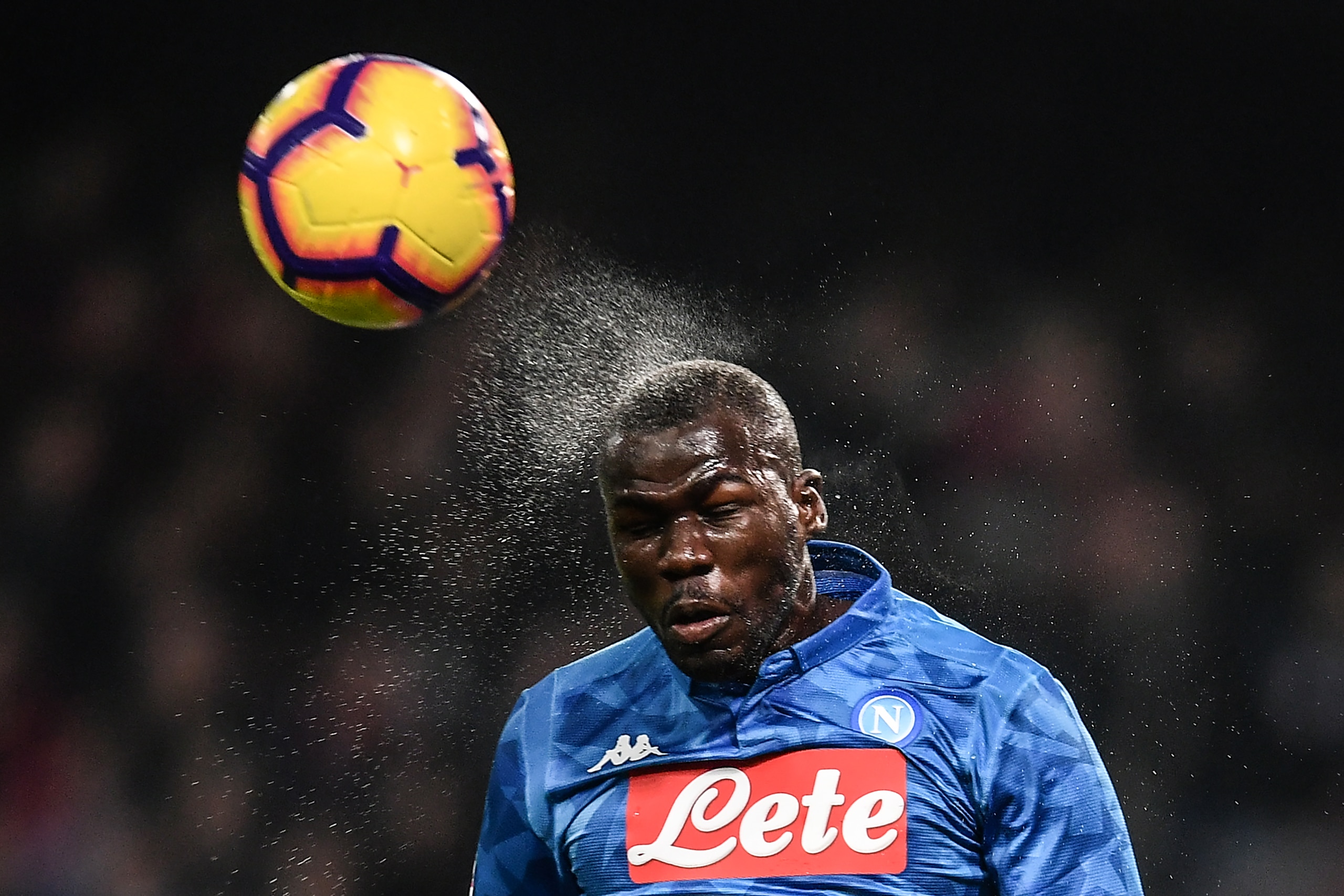 Napoli's Senegalese defender Kalidou Koulibaly heads the ball during the Italian Serie A football match Genoa vs Napoli at the Luigi-Ferraris stadium on November 10, 2018 in Genoa. (Photo by Marco BERTORELLO / AFP)        (Photo credit should read MARCO B