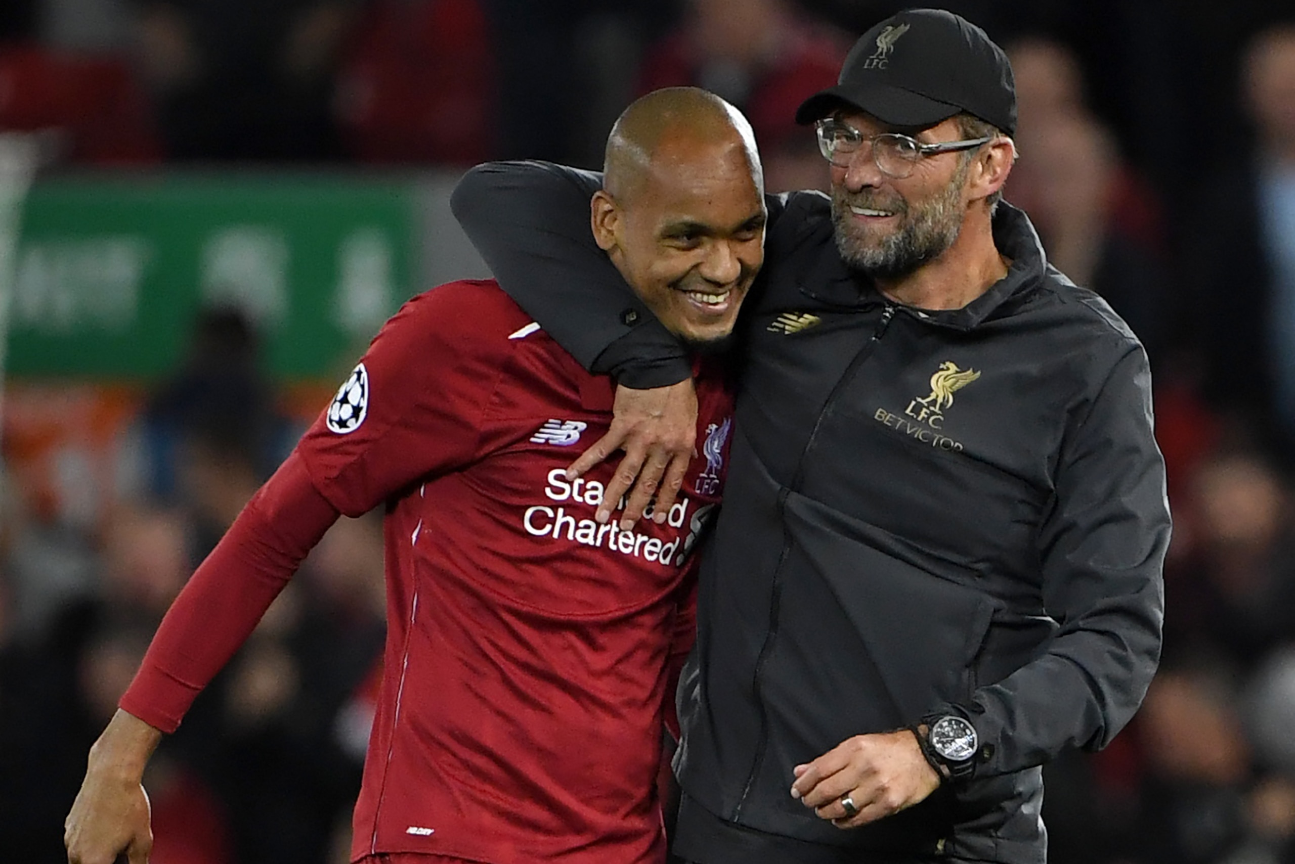 Liverpool's Brazilian midfielder Fabinho (L) and Liverpool's German manager Jurgen Klopp react at the final whistle during the UEFA Champions League group C football match between Liverpool and Paris Saint-Germain at Anfield in Liverpool, north west Engla