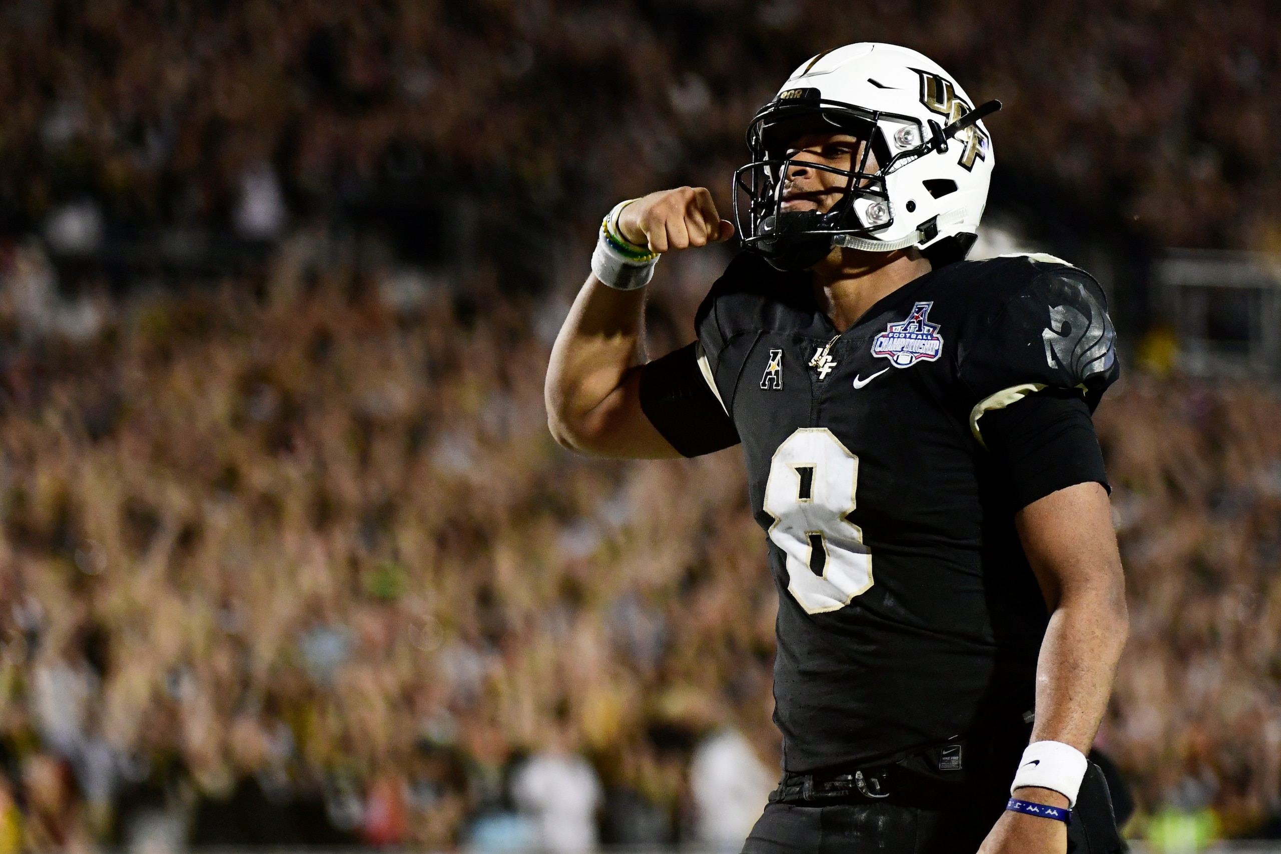 ORLANDO, FLORIDA - DECEMBER 01: Darriel Mack Jr. #8 of the UCF Knights celebrates after running in a touchdown in the fourth quarter of the American Athletic Championship against the Memphis Tigers at Spectrum Stadium on December 01, 2018 in Orlando, Flor