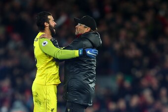 LIVERPOOL, ENGLAND - DECEMBER 02: Jurgen Klopp the manager / head coach of Liverpool celebrates with Alisson Becker of Liverpool as Divock Origi of Liverpool scores a goal to make it 1-0 during the Premier League match between Liverpool FC and Everton FC 