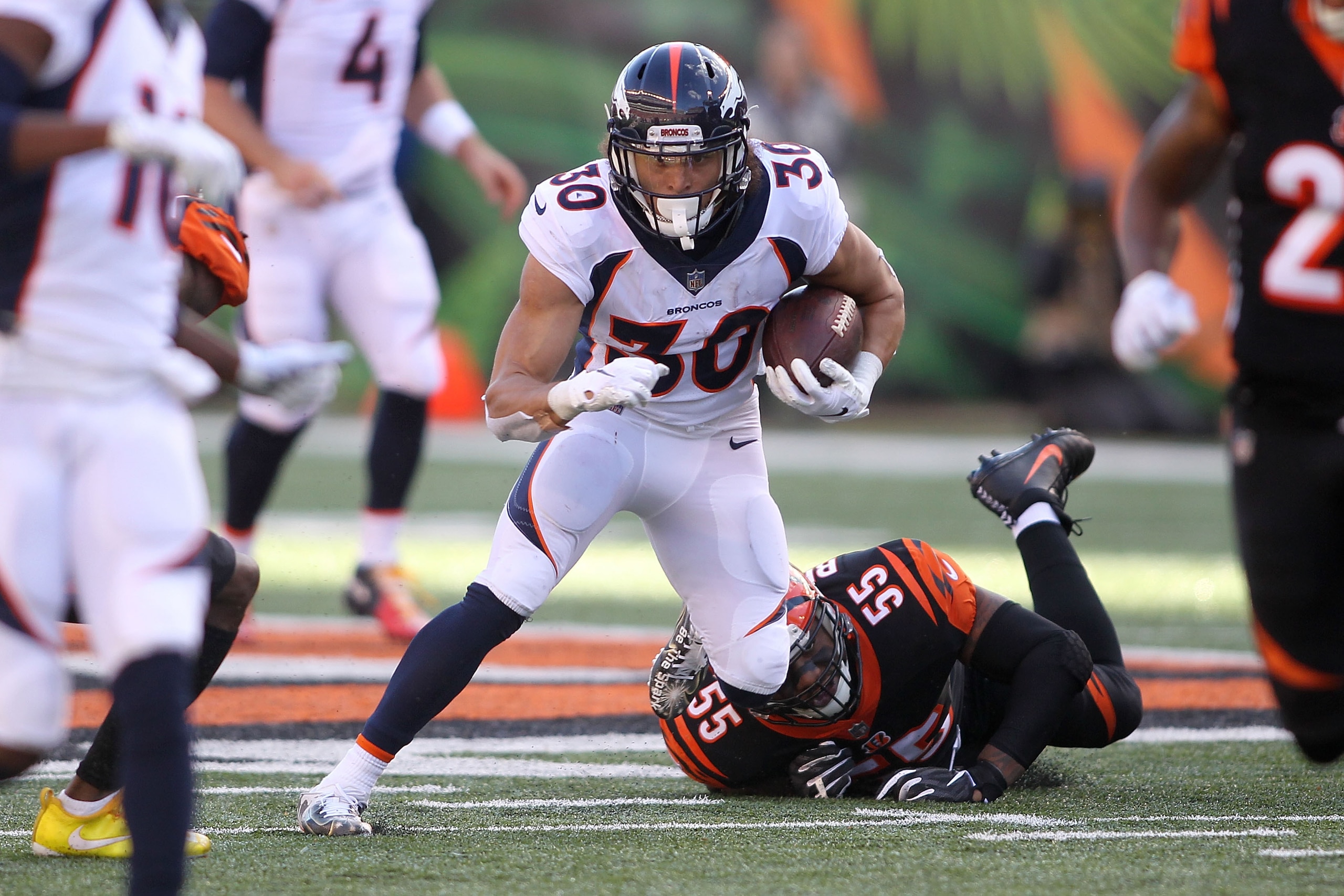 CINCINNATI, OH - DECEMBER 2: Phillip Lindsay #30 of the Denver Broncos slips out of an attempted tackle by Vontaze Burfict #55 of the Cincinnati Bengals during the second quarter at Paul Brown Stadium on December 2, 2018 in Cincinnati, Ohio. (Photo by Jo CINCINNATI, OH - DECEMBER 2: Phillip Lindsay #30 of the Denver Broncos slips out of an attempted tackle by Vontaze Burfict #55 of the Cincinnati Bengals during the second quarter at Paul Brown Stadium on December 2, 2018 in Cincinnati, Ohio. (Photo by Jo