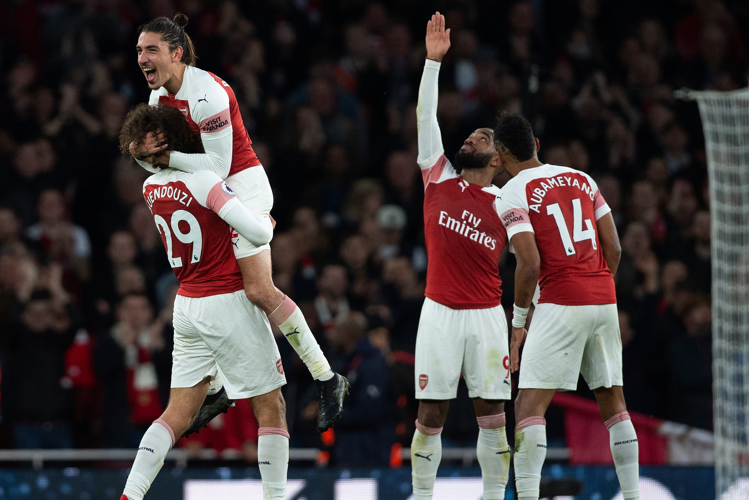 LONDON, ENGLAND - DECEMBER 02: Matteo Guendouzi, Hector Bellerin, Alexandre Lacazette and Pierre-Emerick Aubameyang of Arsenal celebrate victory after winning the Premier League match between Arsenal FC and Tottenham Hotspur FC at the Emirates Stadium on 