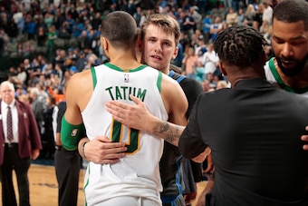 DALLAS, TX - NOVEMBER 24: Jayson Tatum #0 of the Boston Celtics and Luka Doncic #77 of the Dallas Mavericks hug after the game on November 24, 2018 at the American Airlines Center in Dallas, Texas. NOTE TO USER: User expressly acknowledges and agrees that