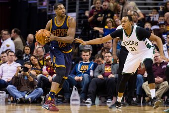 CLEVELAND, OH - MARCH 23: Tristan Thompson #13 of the Cleveland Cavaliers tries to pass around John Henson #31 of the Milwaukee Bucks during the first half at Quicken Loans Arena on March 23, 2016 in Cleveland, Ohio. NOTE TO USER: User expressly acknowled