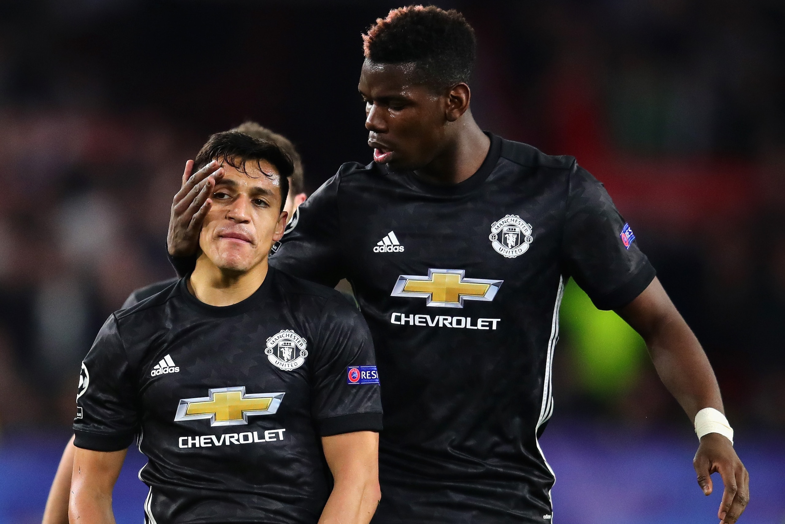 SEVILLE, SPAIN - FEBRUARY 21:  Paul Pogba of Manchester United talks with teammate Alexis Sanchez during the UEFA Champions League Round of 16 First Leg match between Sevilla FC and Manchester United at Estadio Ramon Sanchez Pizjuan on February 21, 2018 i