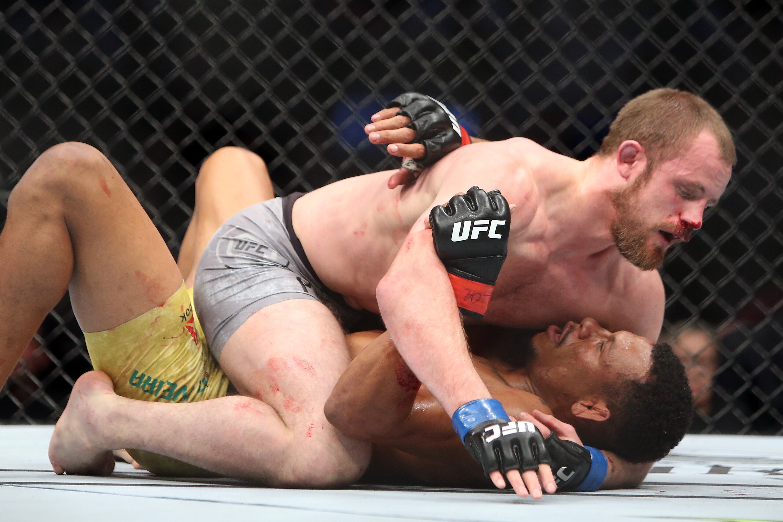 TORONTO, ON - DECEMBER 8:  Gunnar Nelson (top) of Iceland fights against Alex Oliveira of Brazil in a welterweight bout during the UFC 231 event at Scotiabank Arena on December 8, 2018 in Toronto, Canada.  (Photo by Vaughn Ridley/Getty Images)