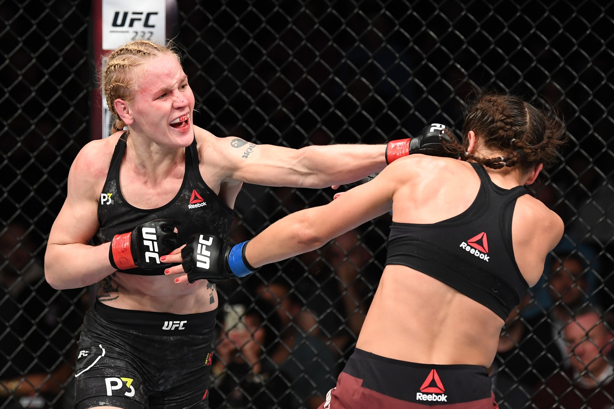 TORONTO, CANADA - DECEMBER 08:  (L-R) Valentina Shevchenko of Kyrgyzstan punches Joanna Jedrzejczyk of Poland in their UFC strawweight championship fight during the UFC 231 event at Scotiabank Arena on December 8, 2018 in Toronto, Canada. (Photo by Josh H