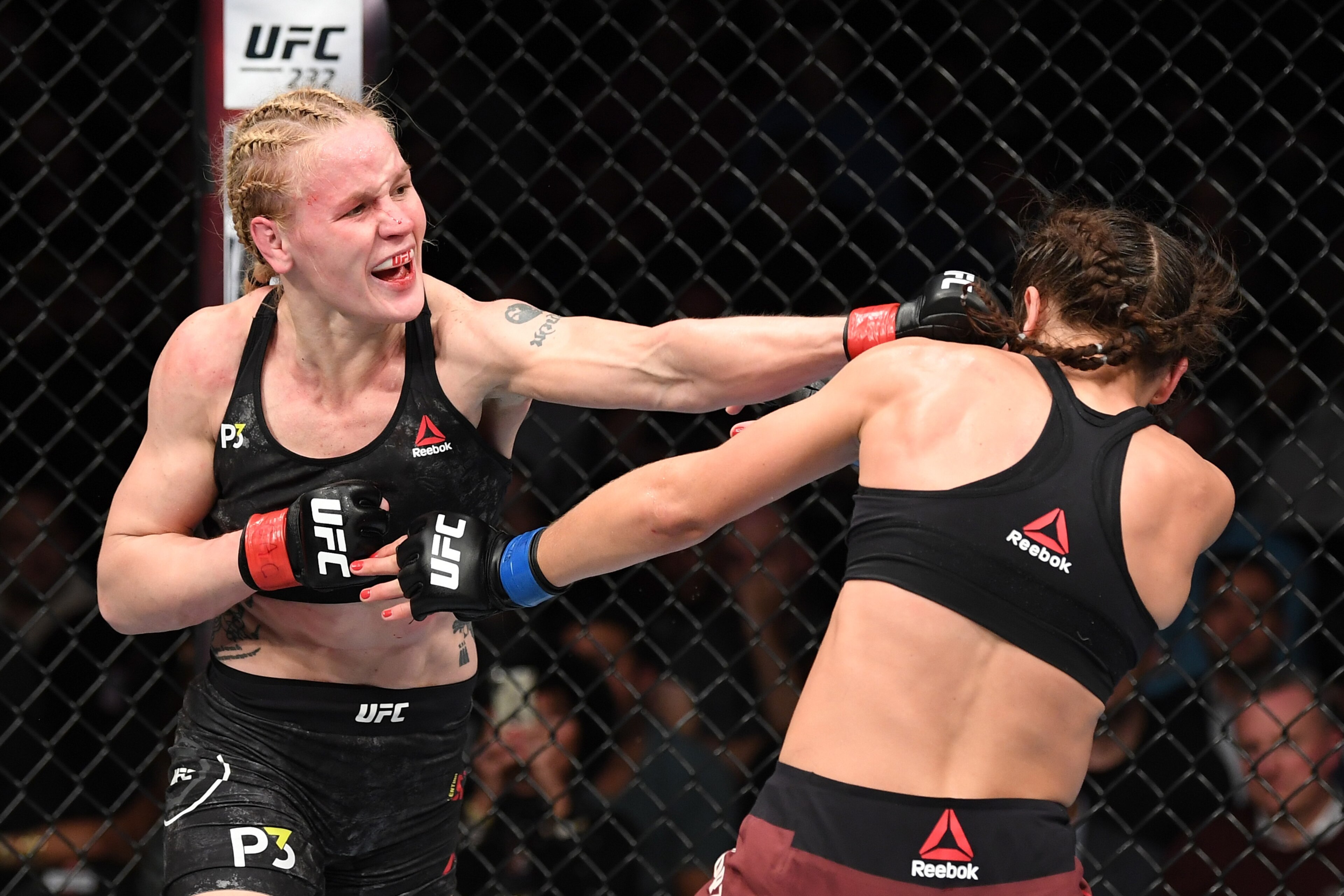 TORONTO, CANADA - DECEMBER 08:  (L-R) Valentina Shevchenko of Kyrgyzstan punches Joanna Jedrzejczyk of Poland in their UFC strawweight championship fight during the UFC 231 event at Scotiabank Arena on December 8, 2018 in Toronto, Canada. (Photo by Josh H