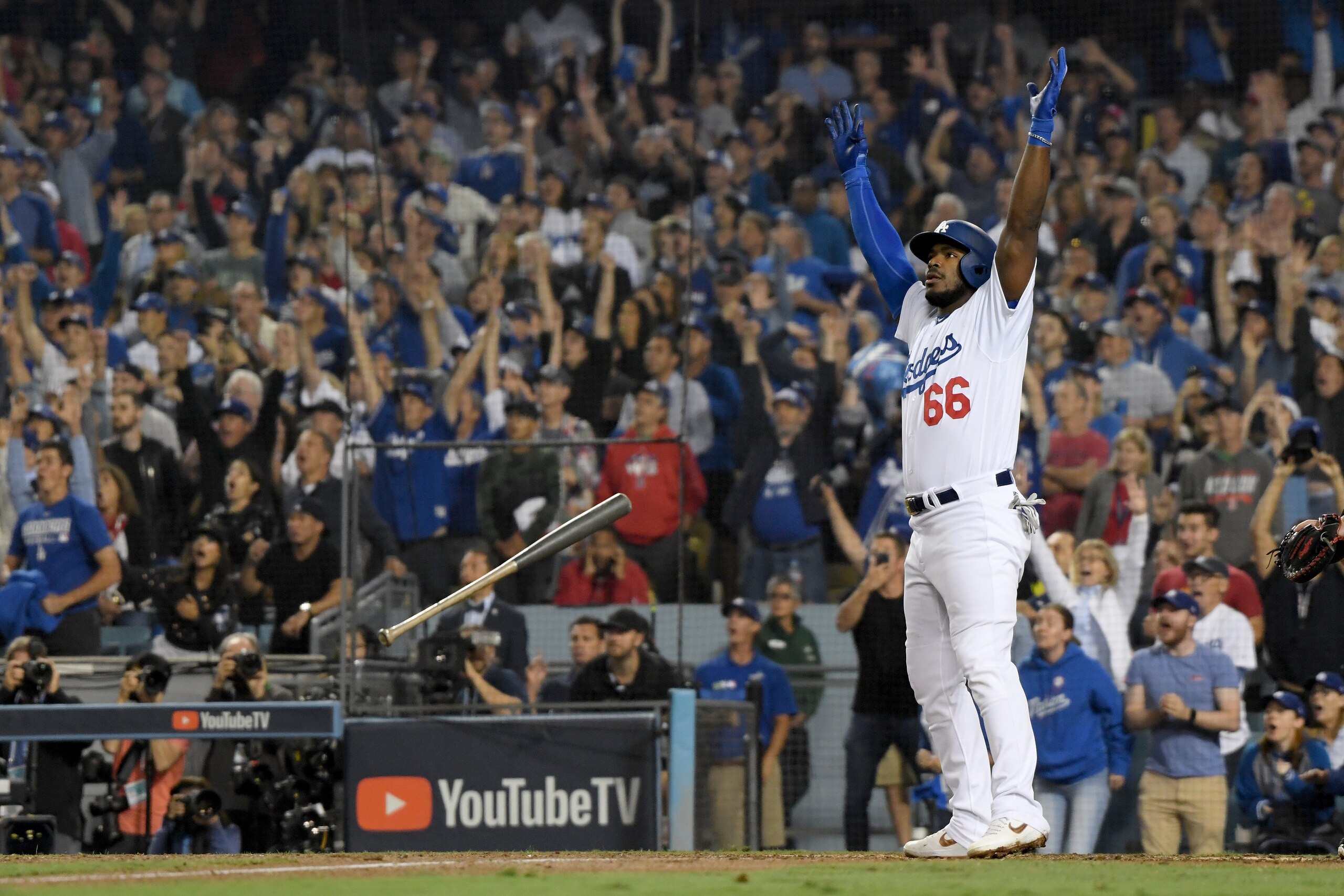LOS ANGELES, CA - OCTOBER 27: Yasiel Puig #66 of the Los Angeles Dodgers tosses his bat aside and celebrates as his hit goes for a three-run home run to left field in the sixth inning of Game Four of the 2018 World Series against pitcher Eduardo Rodrigue LOS ANGELES, CA - OCTOBER 27: Yasiel Puig #66 of the Los Angeles Dodgers tosses his bat aside and celebrates as his hit goes for a three-run home run to left field in the sixth inning of Game Four of the 2018 World Series against pitcher Eduardo Rodrigue