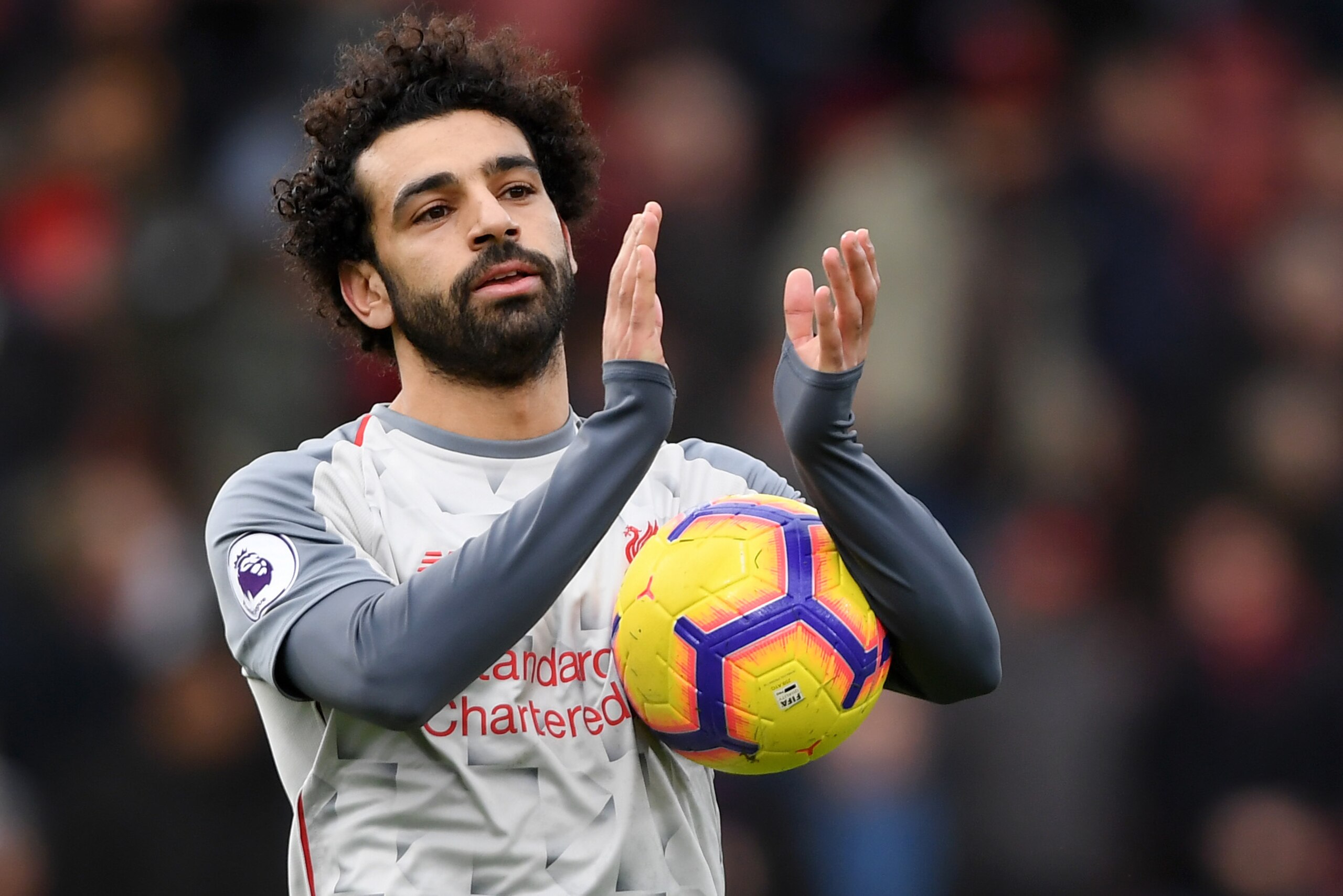 BOURNEMOUTH, ENGLAND - DECEMBER 08:  Mohamed Salah of Liverpool collects the match ball after scoring a hattrick and acknowledges the fans after the Premier League match between AFC Bournemouth and Liverpool FC at Vitality Stadium on December 8, 2018 in B