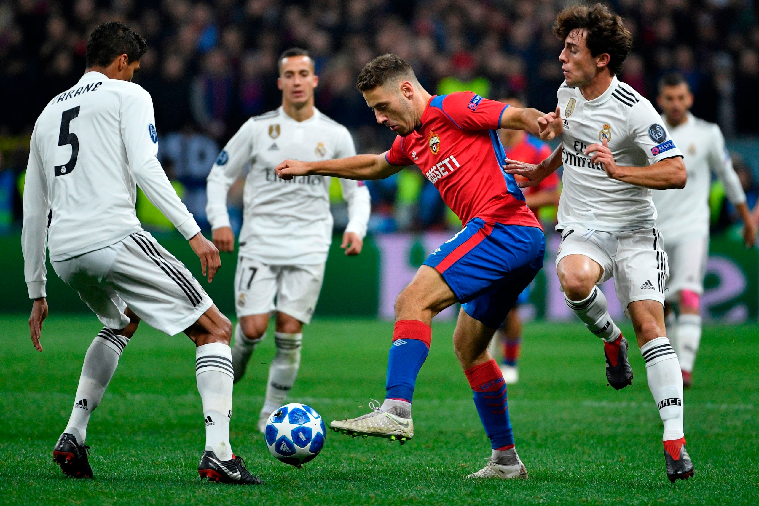 From L: Real Madrid's French defender Raphael Varane, CSKA Moscow's Croatian midfielder Nikola Vlasic and Real Madrid's Spanish defender Alvaro Odriozola vie for the ball during the UEFA Champions League group G football match between PFC CSKA Moscow and 