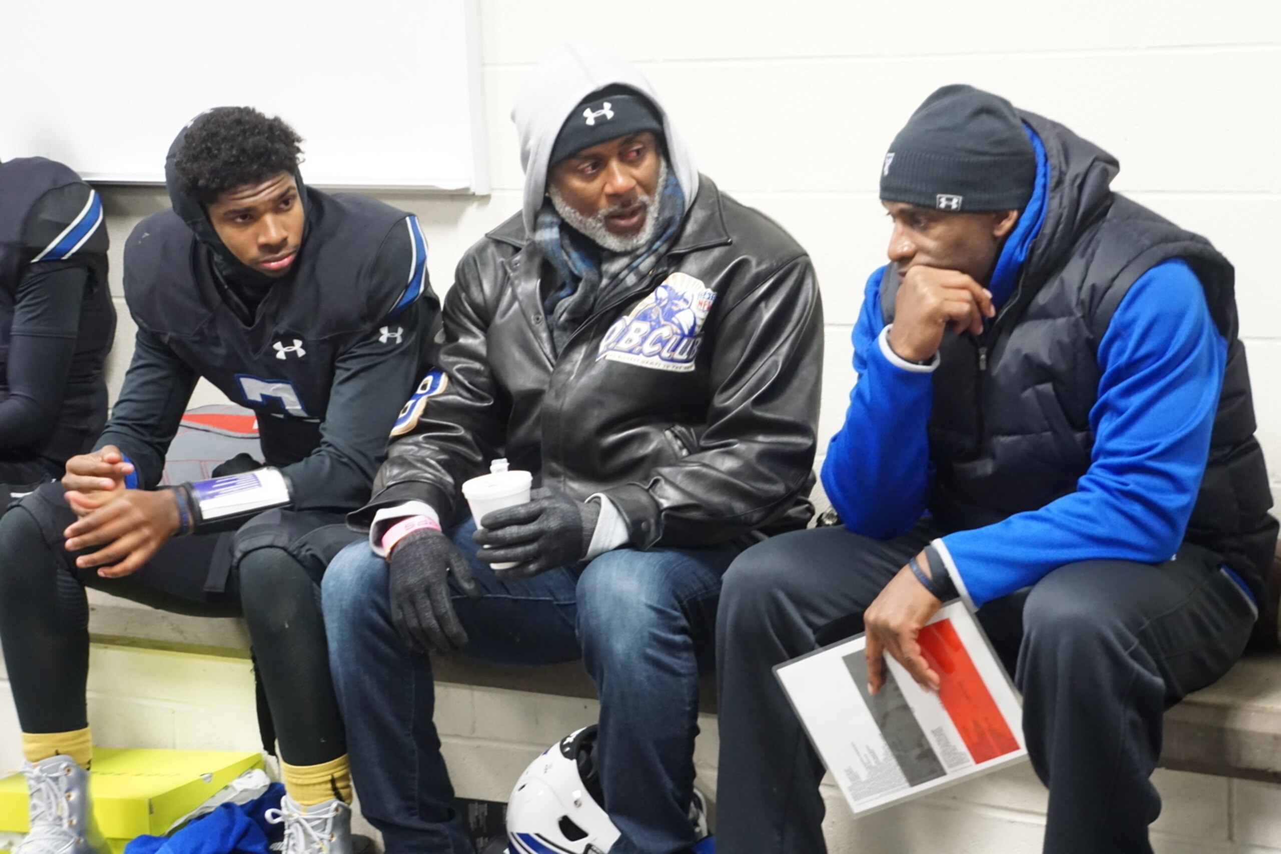 Shedeur Sanders, Jeff Blake and Deion Sanders confer.