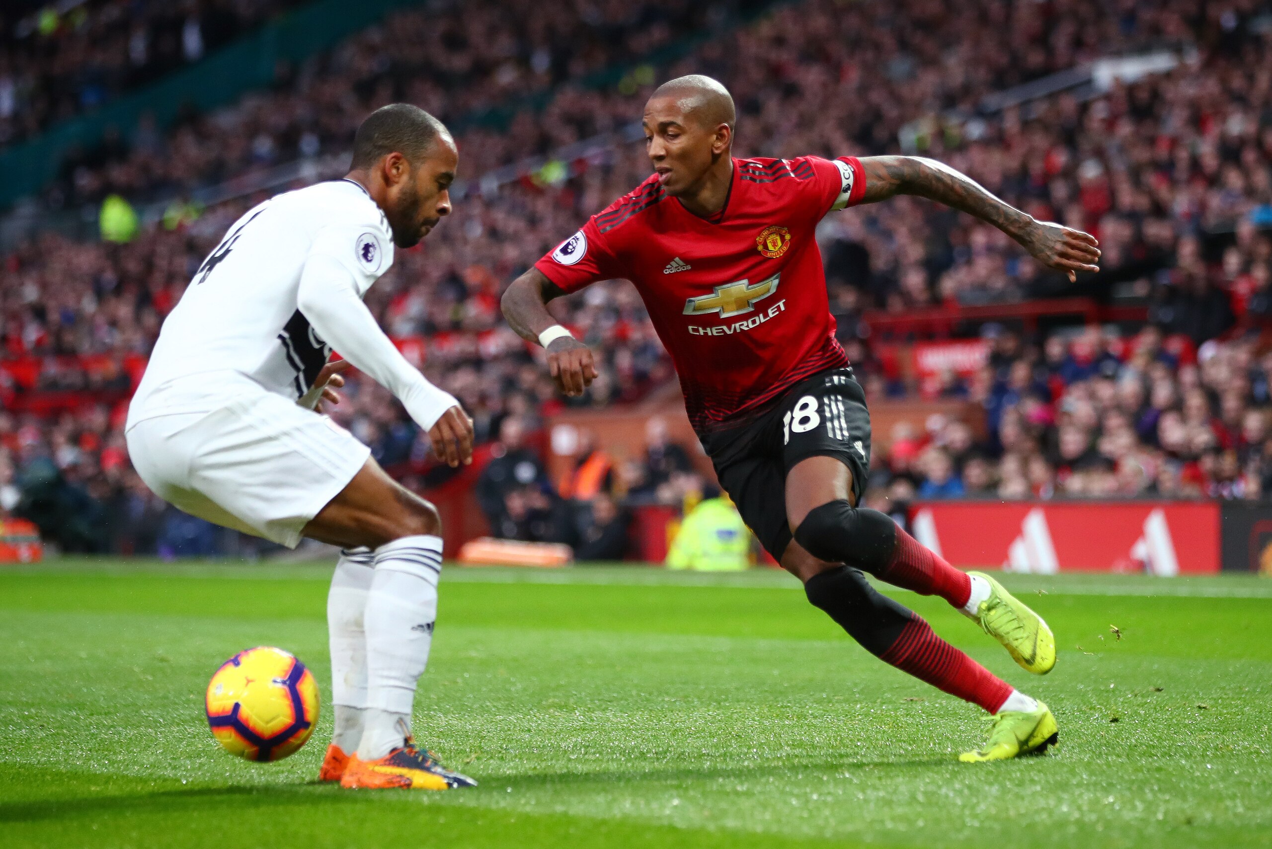 MANCHESTER, ENGLAND - DECEMBER 08:  Ashley Young of Manchester United is challenged by Denis Odoi of Fulham during the Premier League match between Manchester United and Fulham FC at Old Trafford on December 8, 2018 in Manchester, United Kingdom.  (Photo 