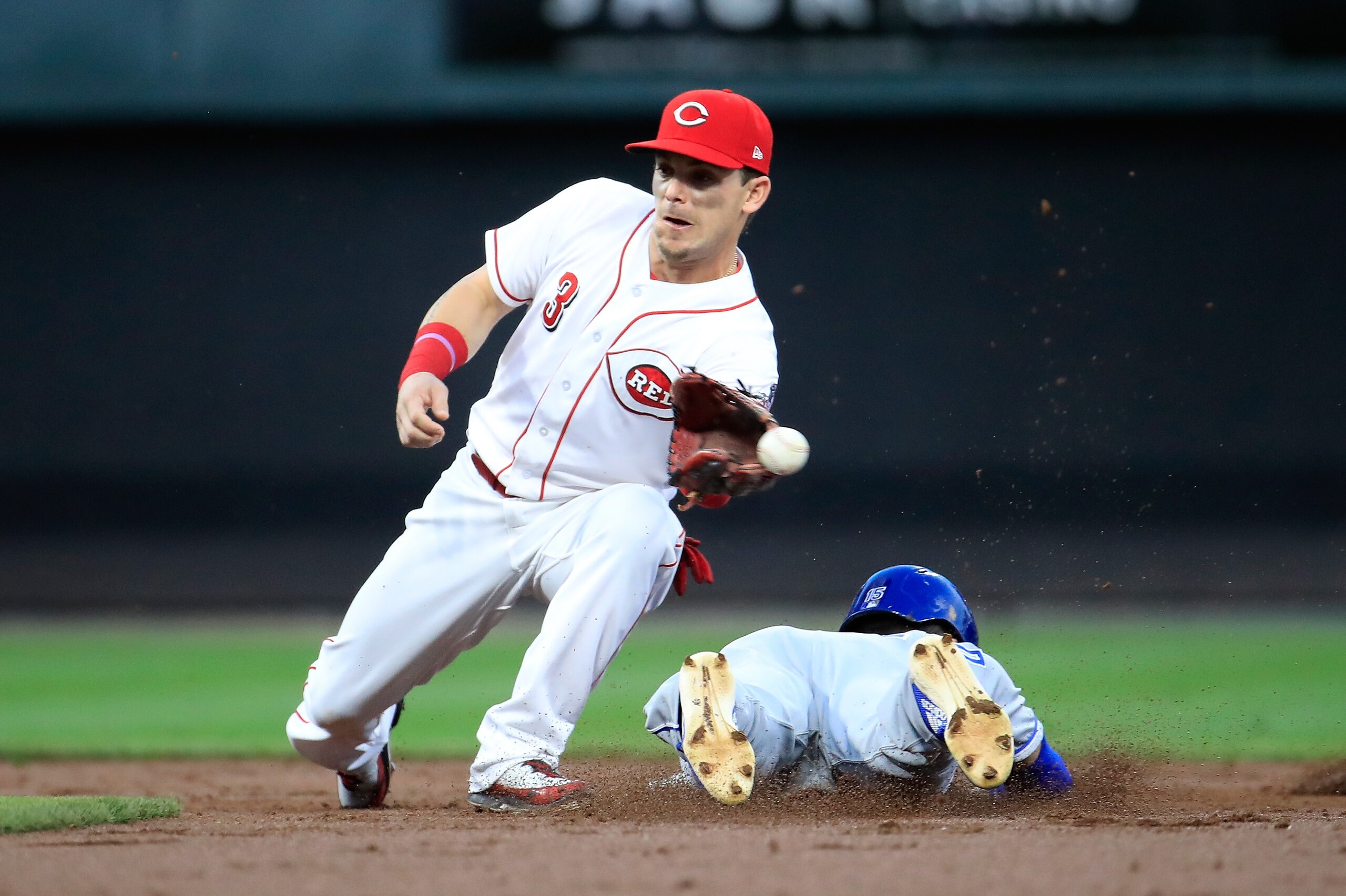 CINCINNATI, OH - SEPTEMBER 26:  Scooter Gennett #3 of the Cincinnati Reds cant control the ball as Whit Merrifield #15 Kansas City Royals slides safely into second base for a stolen base at Great American Ball Park on September 26, 2018 in Cincinnati, Ohi
