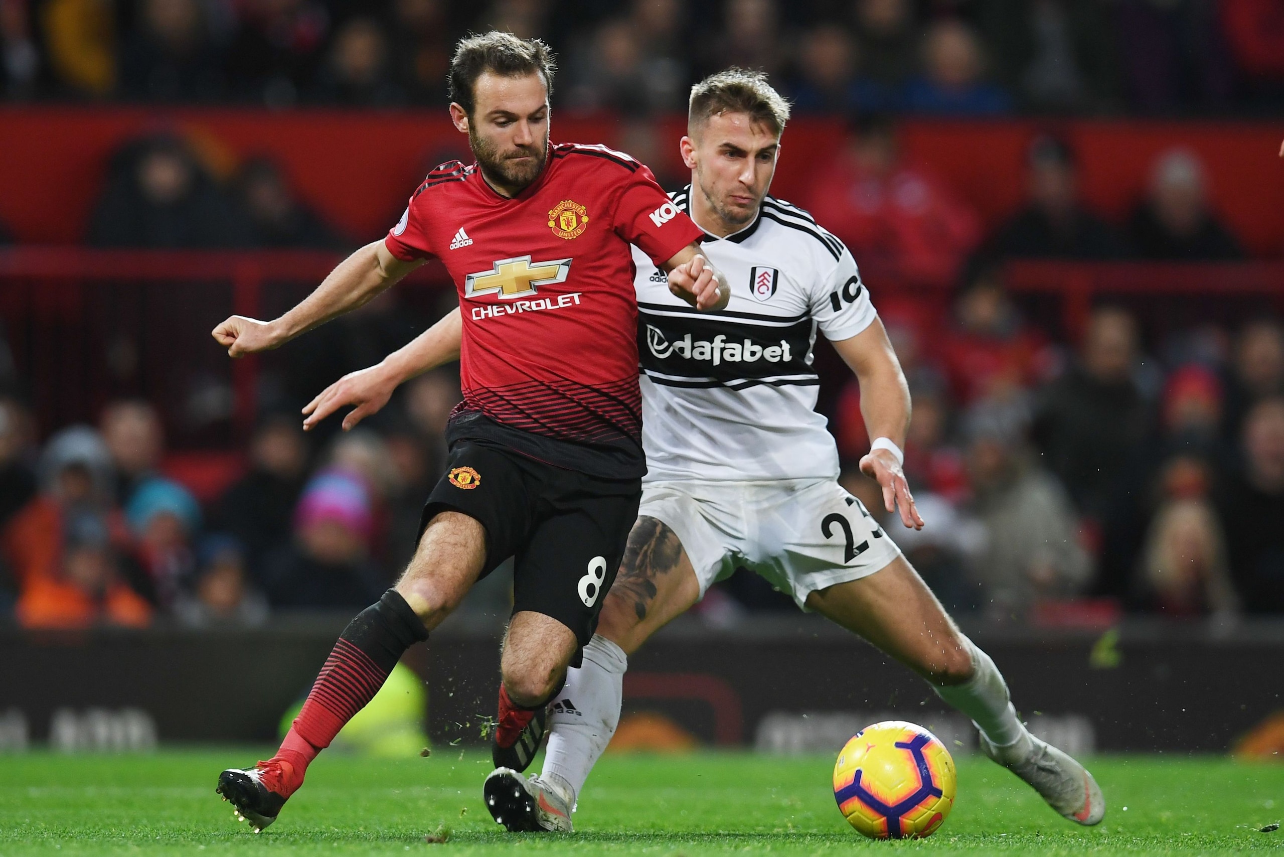 Manchester United's Spanish midfielder Juan Mata (L) vies with Fulham's English defender Joe Bryan during the English Premier League football match between Manchester United and Fulham at Old Trafford in Manchester, north west England, on December 8, 2018