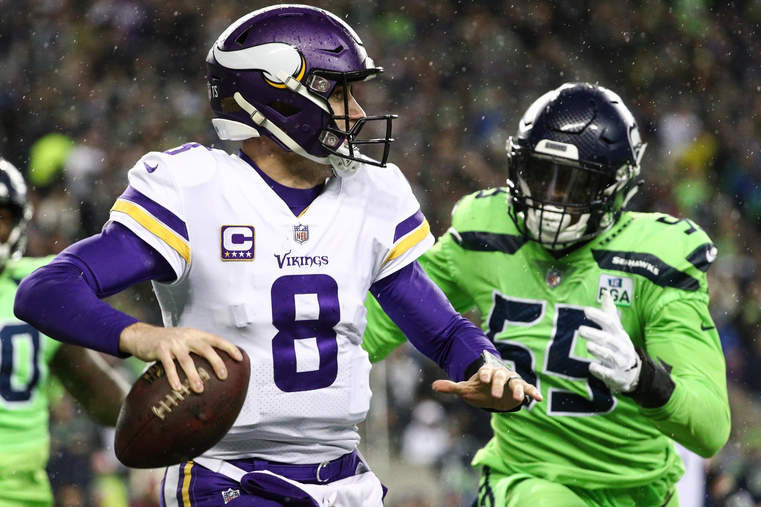 SEATTLE, WA - DECEMBER 10: Kirk Cousins #8 of the Minnesota Vikings looks to throw the ball as Frank Clark #55 of the Seattle Seahawks looks for the sack in the second quarter at CenturyLink Field on December 10, 2018 in Seattle, Washington. (Photo by Abb