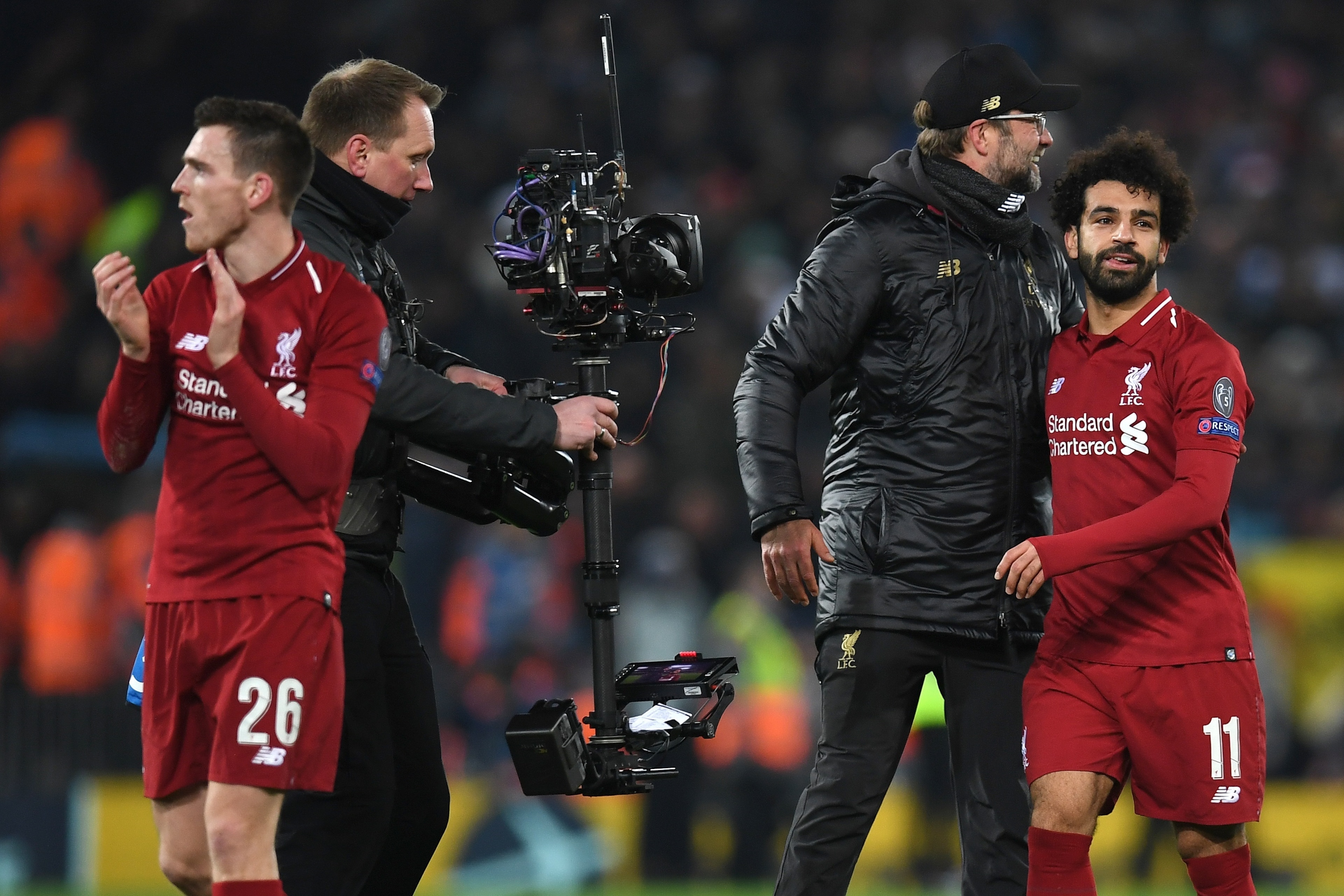 Liverpool's German manager Jurgen Klopp (2R) celebrates with Liverpool's Egyptian midfielder Mohamed Salah (R) and Liverpool's Scottish defender Andrew Robertson during the UEFA Champions League group C football match between Liverpool and Napoli at Anfie