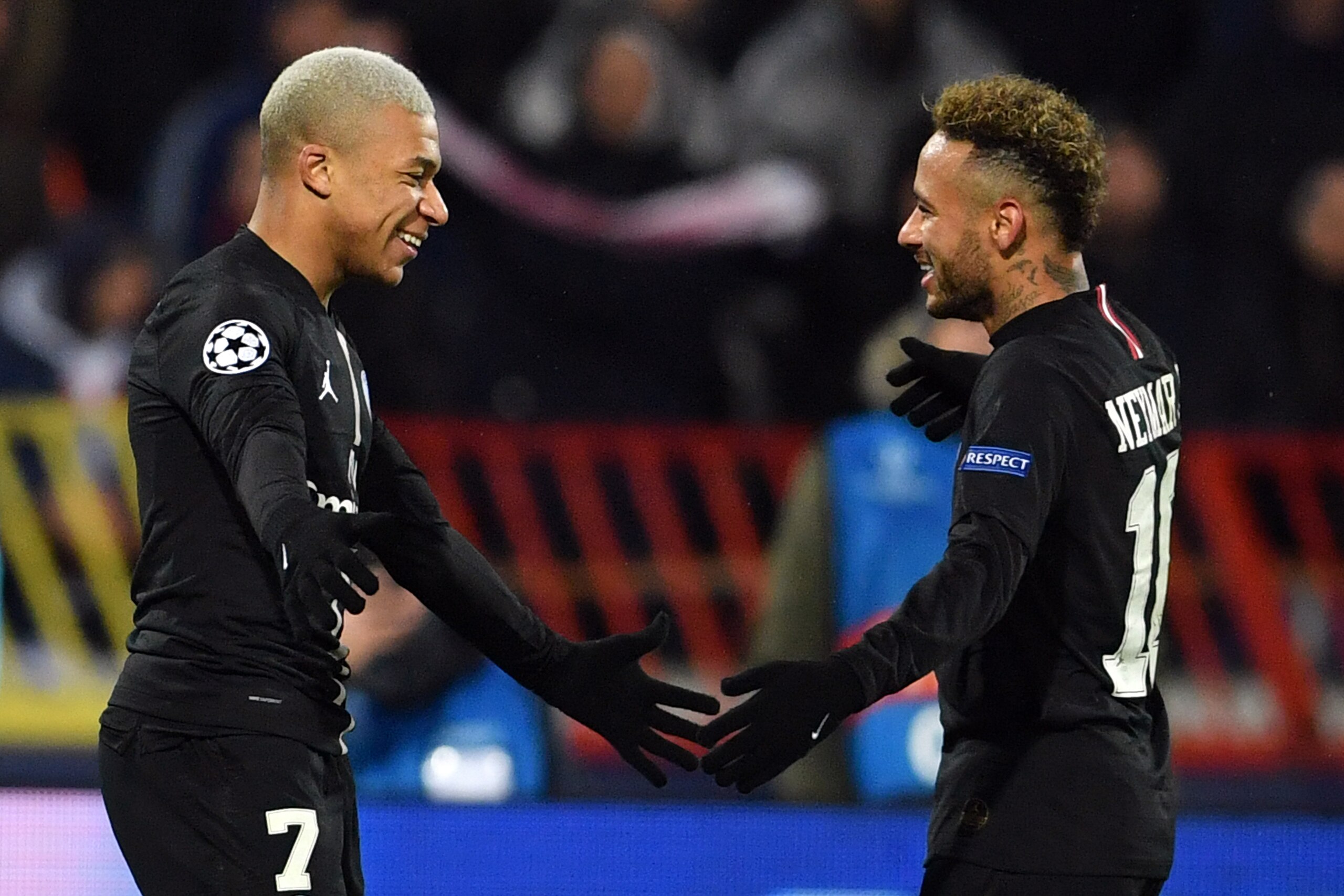 Paris Saint-Germain's French forward Kylian Mbappe (L) celebrates with Paris Saint-Germain's Brazilian forward Neymar after scoring a goal during the European Champions League football match Crvena Zvezda Belgrade vs Paris Saint-Germain (PSG) on December 