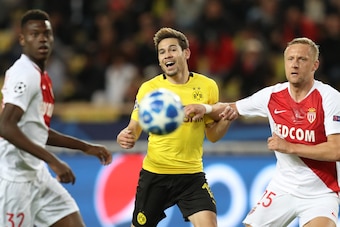 (LtoR) Monaco's French defender Benoit Badiashile, Dortmund's Portuguese defender Raphael Guerreiro and Monaco's Polish defender Kamil Glik eye the ball during the UEFA Champions League Group A football match between Monaco and Dortmund at the Louis II st