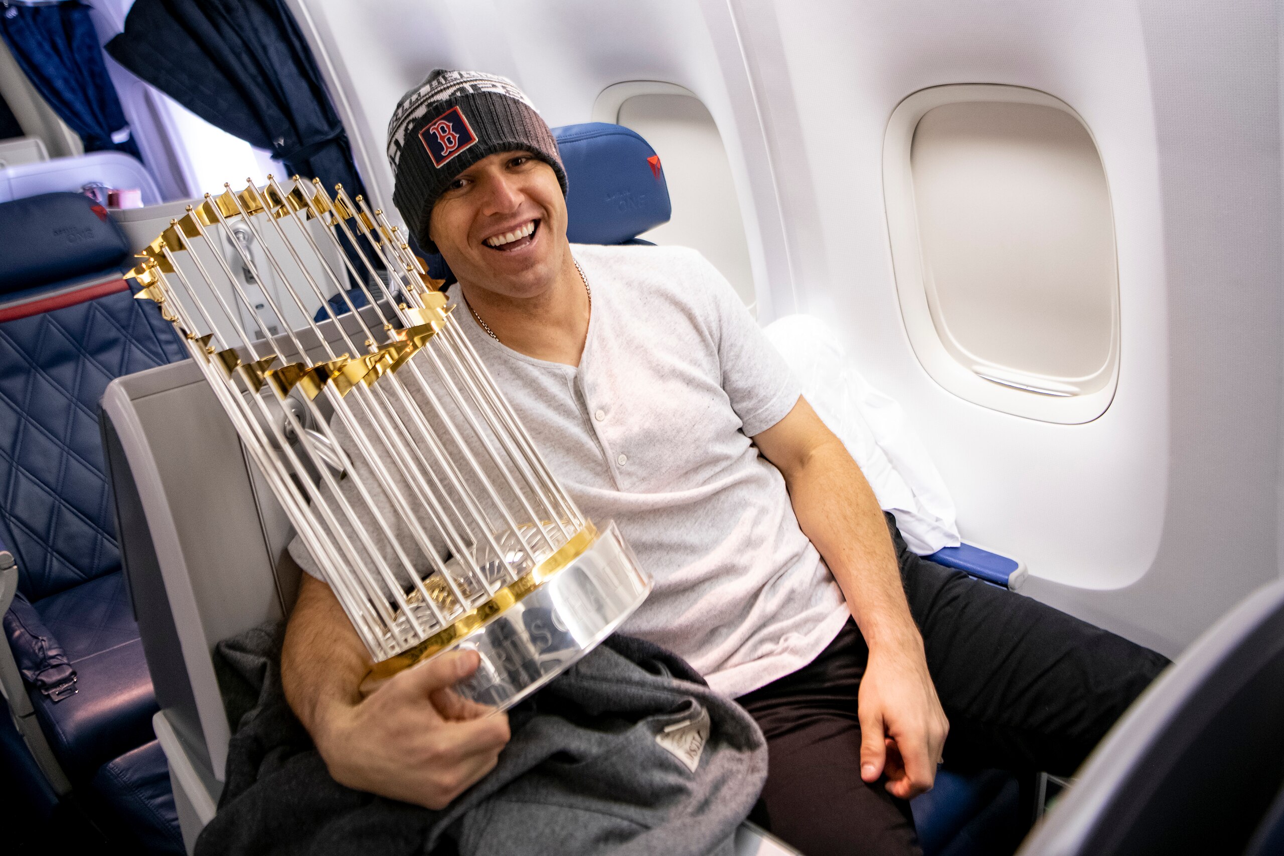 LOS ANGELES, CA - OCTOBER 29: Ian Kinsler #5 of the Boston Red Sox holds the World Series trophy as the team travels to Boston after winning the 2018 World Series against the Los Angeles Dodgers on October 29, 2018 in Los Angeles, California. (Photo by Bi