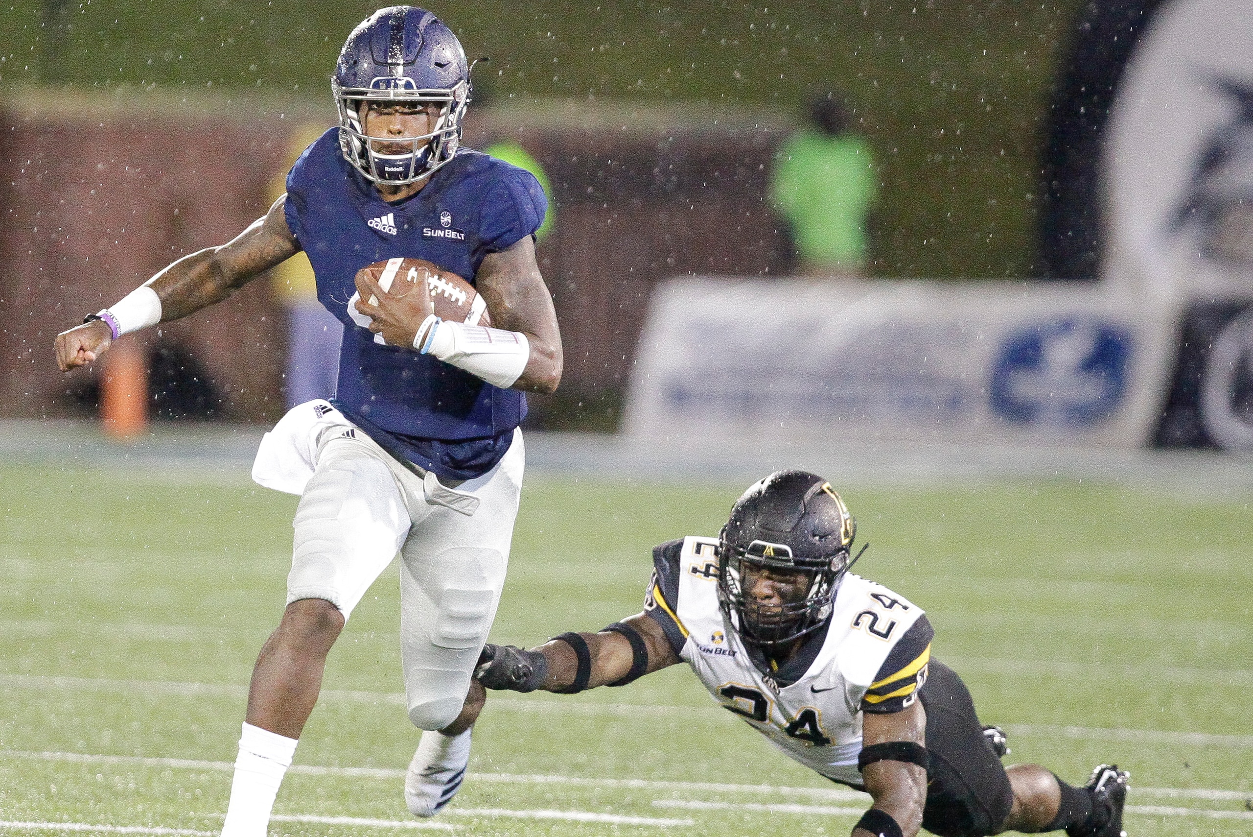 STATESBORO, GA - OCTOBER 25: Shai Werts #4 of the Georgia Southern Eagles moves the ball for a gain as Akeem Davis-Gaither #24 of the Appalachian State Mountaineers tries to tackle during the second quarter on October 25, 2018 in Statesboro, Georgia. (Pho